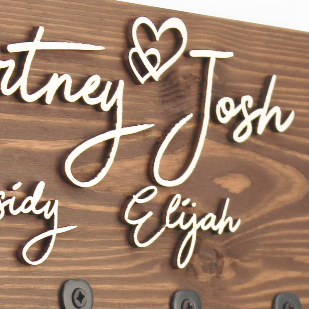 rosewood key holder with a raised personalised design, a perfect couple's gift or new home gift to add elegance and style."