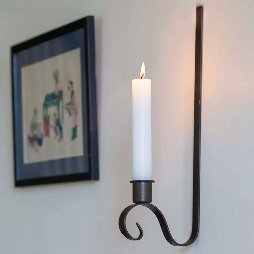 "Dark brown wall candle holder made from metal, perfect for creating a calming ambiance in any room of your home."