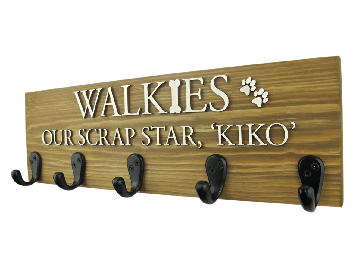 This personalised dog lead hook in a light oak wood finish features raised natural wood lettering, offering a warm and timeless look. The large 5-hook design provides plenty of space to organize your pet’s leads, collars, and accessories. Handcrafted from premium wood, this piece combines style and functionality, adding a light, natural touch to your home while keeping your pet's essentials neatly stored.