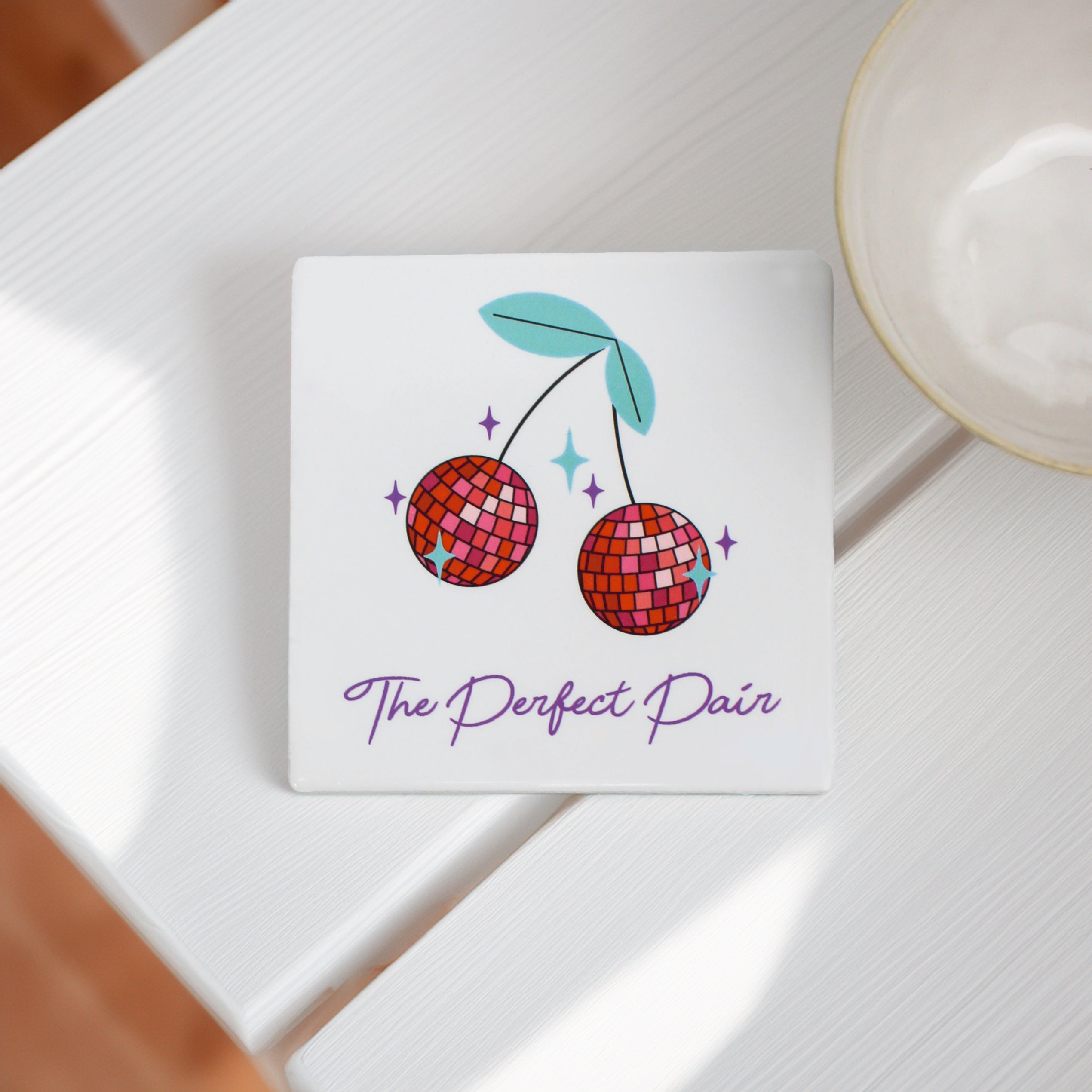 "Stylish Disco Cherry Ceramic Coasters with a bold, fun design in reds, pinks, and turquoise, perfect for adding a pop of personality to your space." can be personalised with your own wording