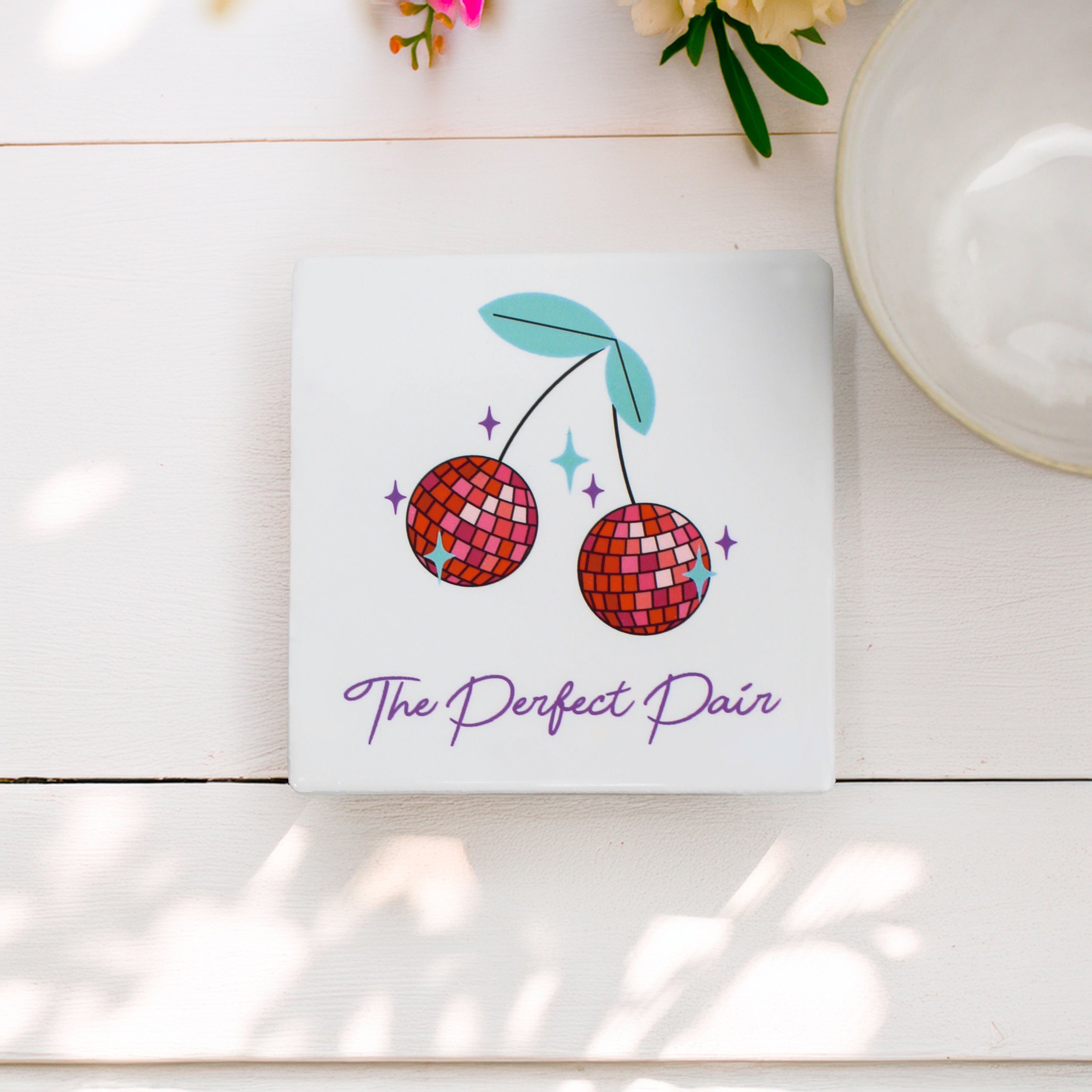 "The Disco Cherry Coaster Set in matte finish, showcasing a funky cherry disco ball design with vibrant colours and playful ‘The Perfect Pair’ wording."