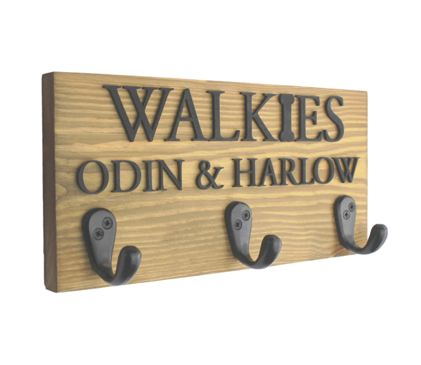 This personalised dog lead hook in a light oak finish features raised black lettering, offering a sleek and modern design. The 3-hook layout provides the perfect amount of space to organize your pet’s leads, collars, and accessories. Handcrafted from premium wood, this stylish and functional piece adds a touch of elegance to your home while keeping everything neatly arranged.