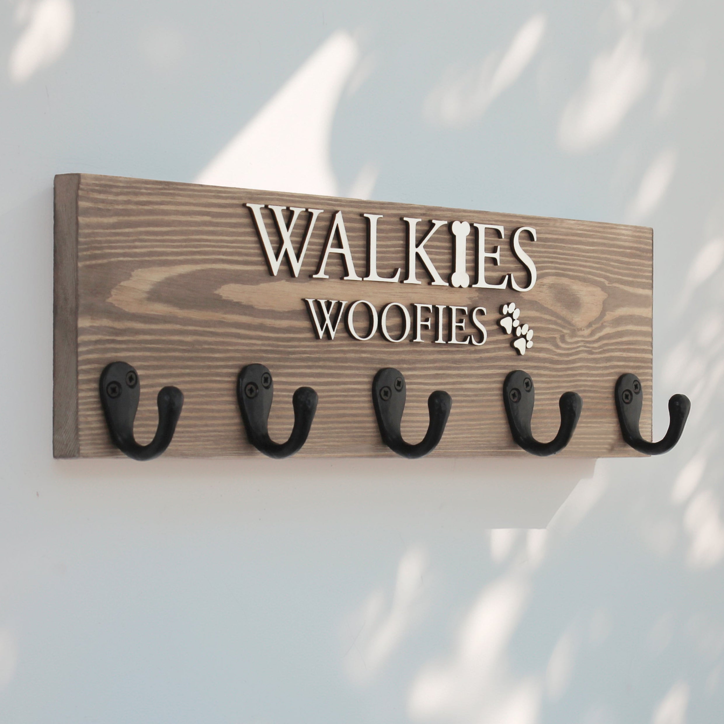 This personalised dog lead hook in a rich walnut finish features raised lettering, offering a sophisticated and timeless design. The large 5-hook layout provides ample space to organize your pet’s leads, collars, and accessories, while adding an elegant touch to your home. Handcrafted from premium wood, it combines both style and practicality, making it a perfect addition to your pet’s corner
