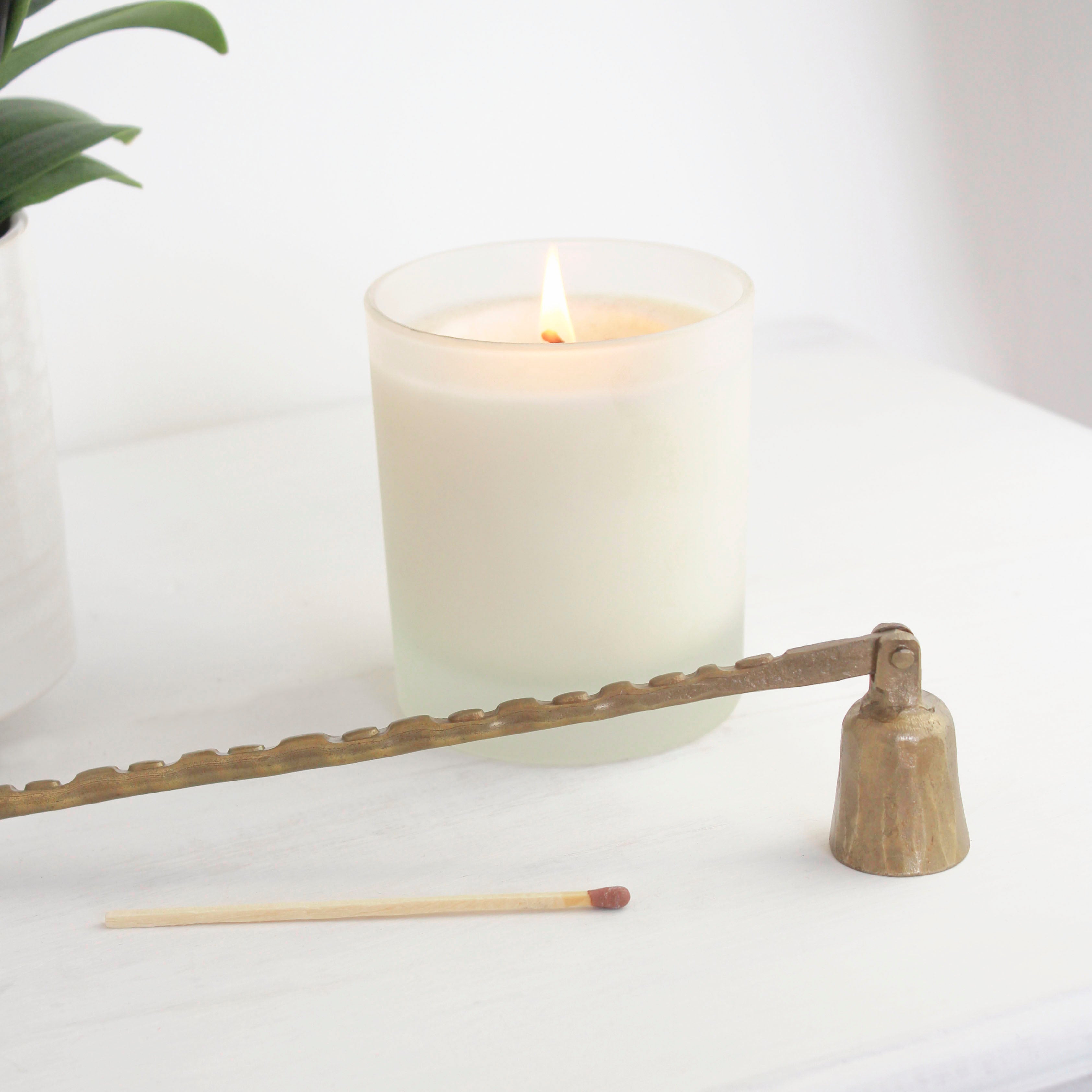 "Hand-forged brass artisan snuffer, expertly crafted for a timeless and elegant addition to your candle care routine."