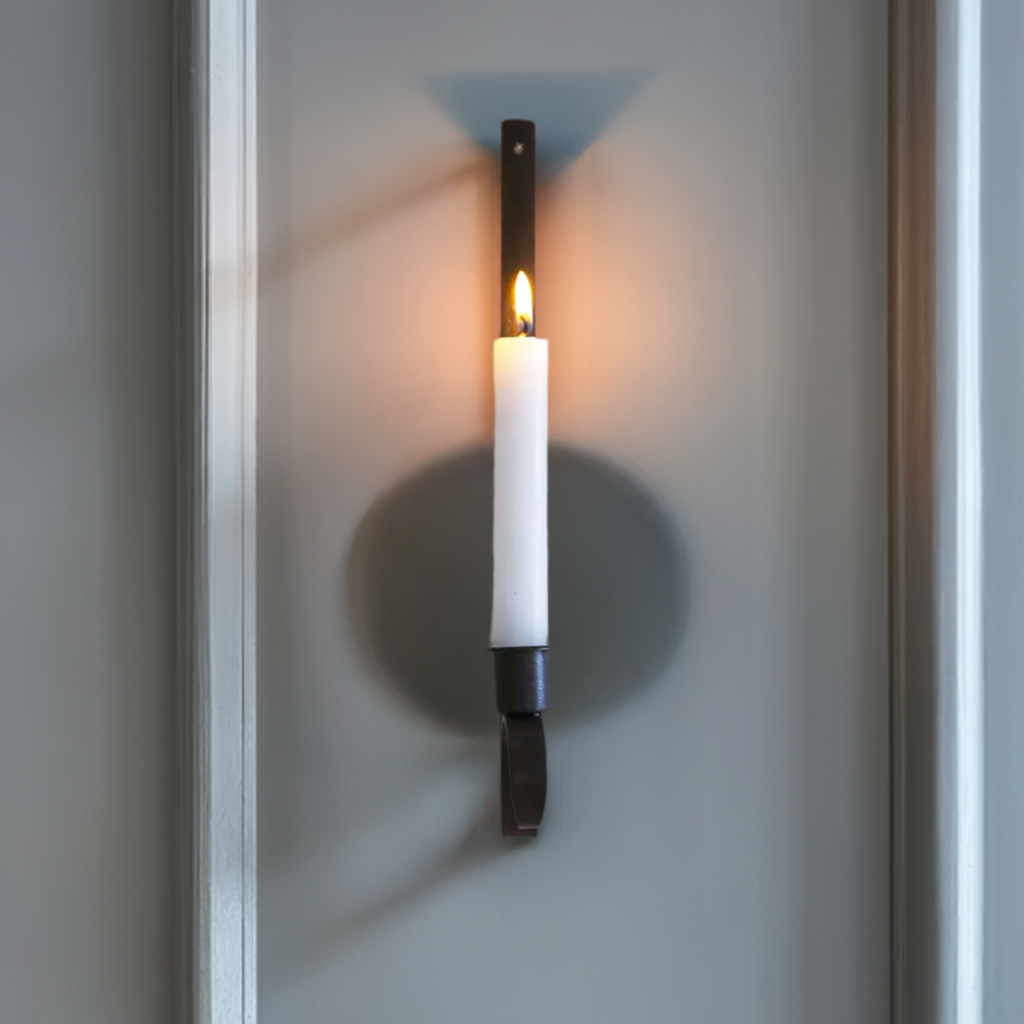 "Rustic iron wall candle holder, adding a cozy, flickering glow to your home décor with its charming design."