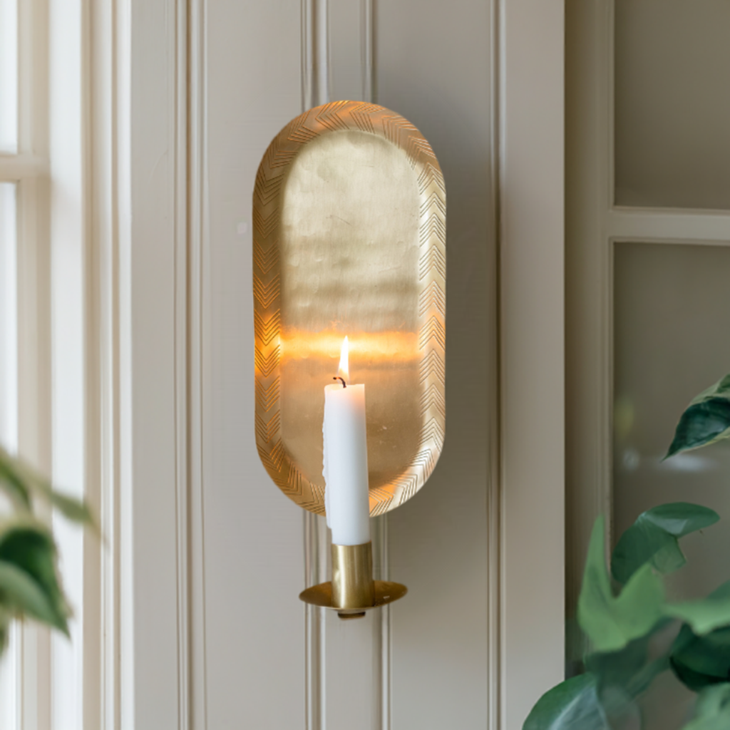 "Elegant wall sconce made from handcrafted brass, casting a warm, magical glow with a textured hammered finish."