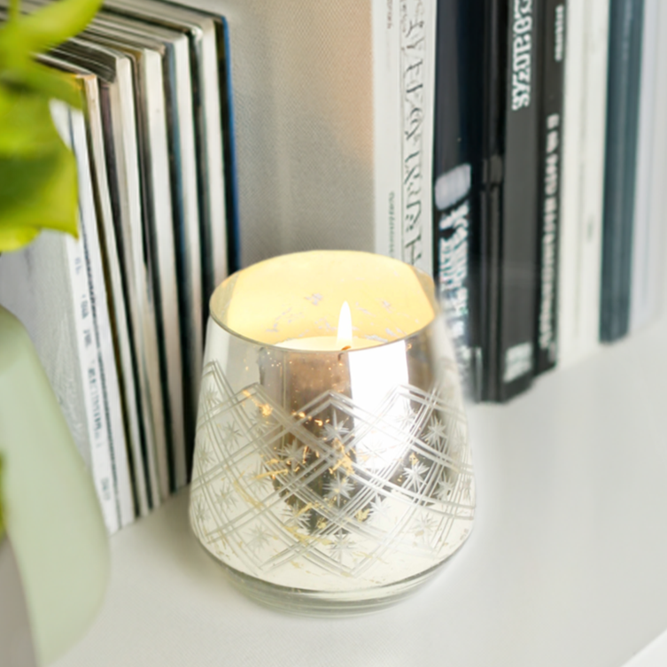 "Timeless glass candle holder with shimmering gold and silver accents, ideal for dinner parties or special occasions."