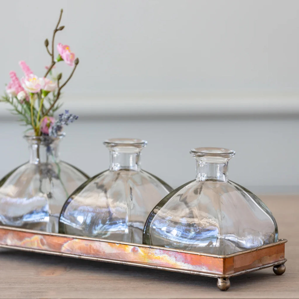 Elegant Glass Bottle Vase Set on Copper Tray