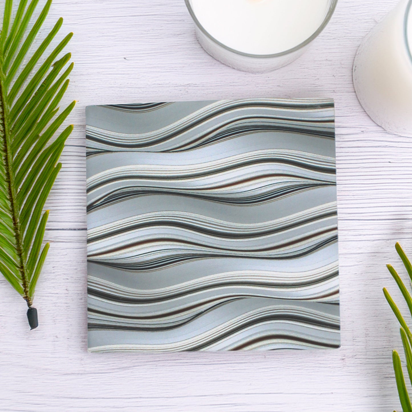 Bring effortless style to any space with our Grey Waves Pattern Ceramic Coaster Set, featuring a beautifully curated mix of intricate wave-inspired designs in classic grey tones, this set of five adds a touch of elegance to any table.

Available to purchase in either a matte or gloss finish, allowing you to choose the perfect look for your space.

 Cork-backed base for both beauty and practicality.

A thoughtful gift for birthdays, housewarmings, dinner parties, or teachers, these coasters bring charm to an