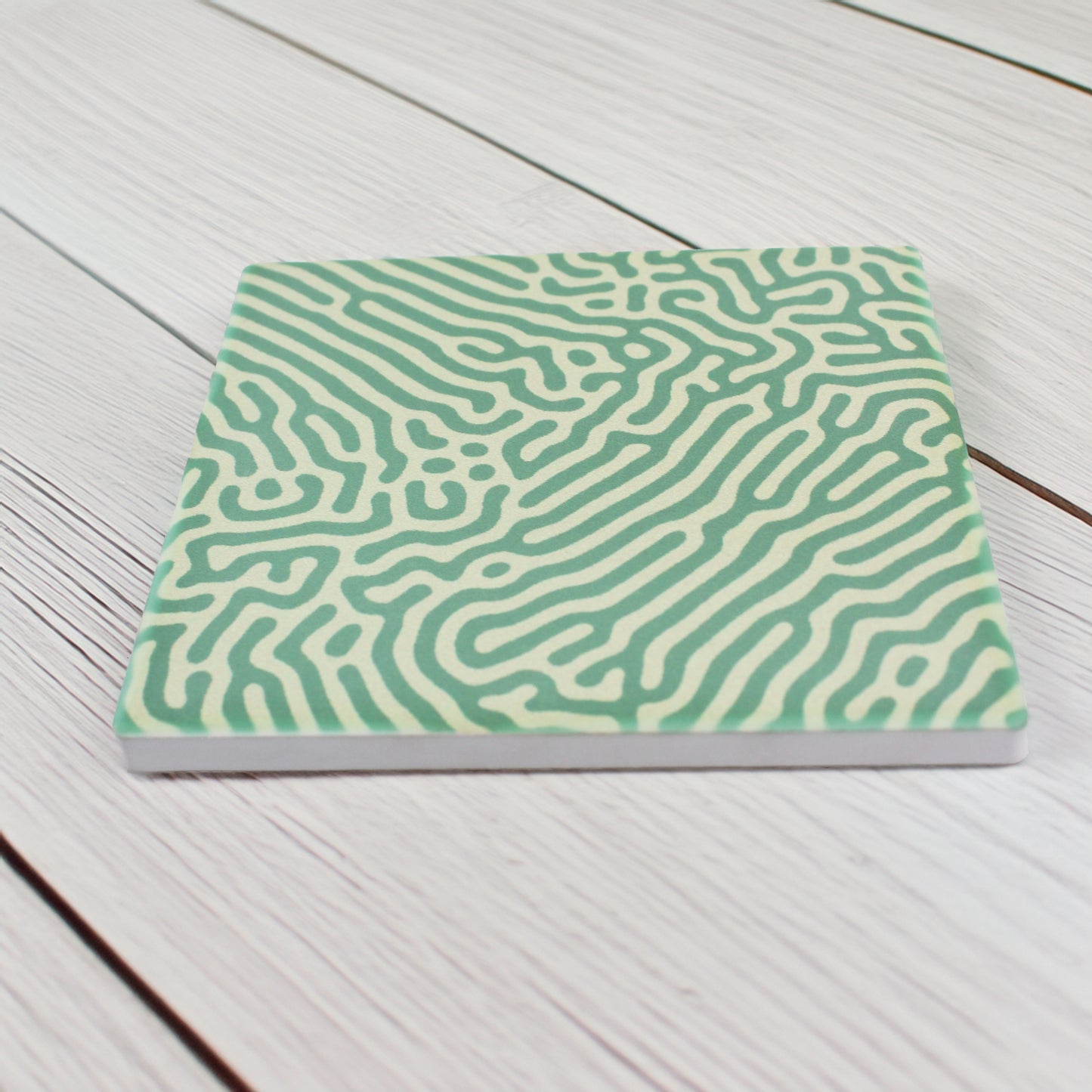 Add a modern vibrant touch to your space with our Abstract Green Pattern Ceramic Coaster Set, this set of four features one striking variation of bold, abstract green patterns, bringing a dynamic and stylish accent to your table.

Available in matte or gloss finish to match your preferred style.

Each coaster is finished with a crisp white, cork-backed base for both elegance and practicality.

Each coaster measures 10cm x 10cm. 