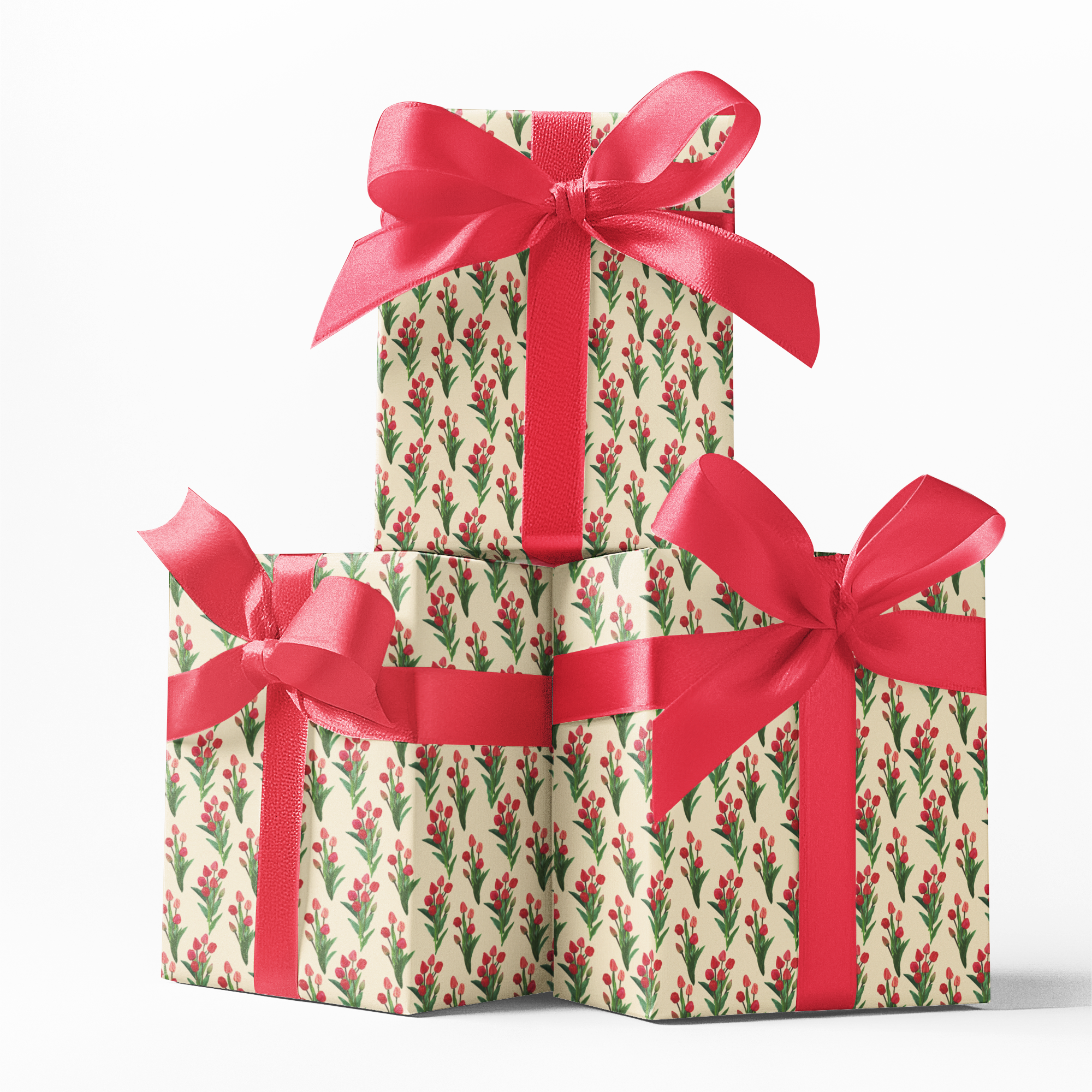Stack of gift wrapped boxes with floral tulip pattern and red ribbons on a white background