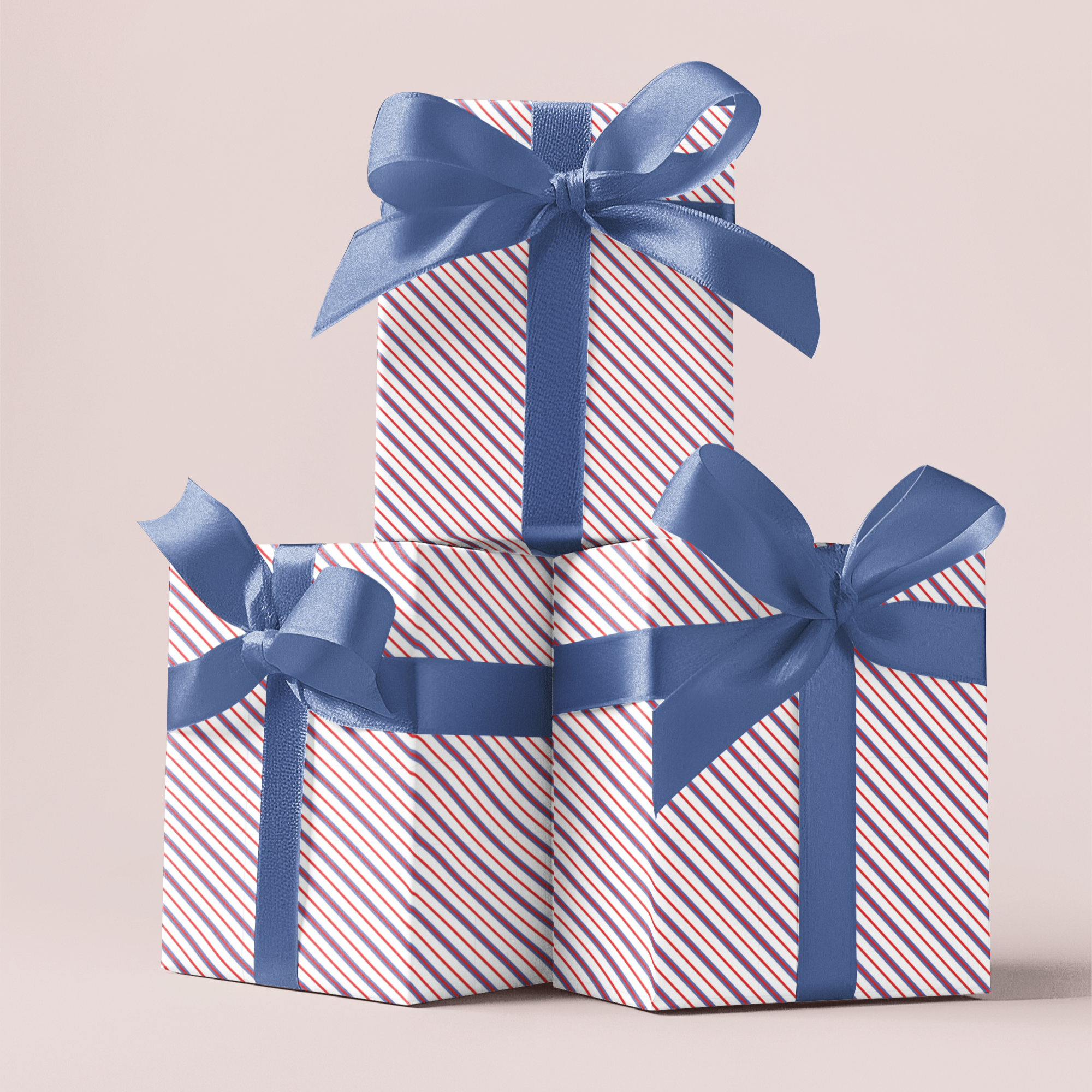 Two gift boxes with blue ribbons stacked on a light background