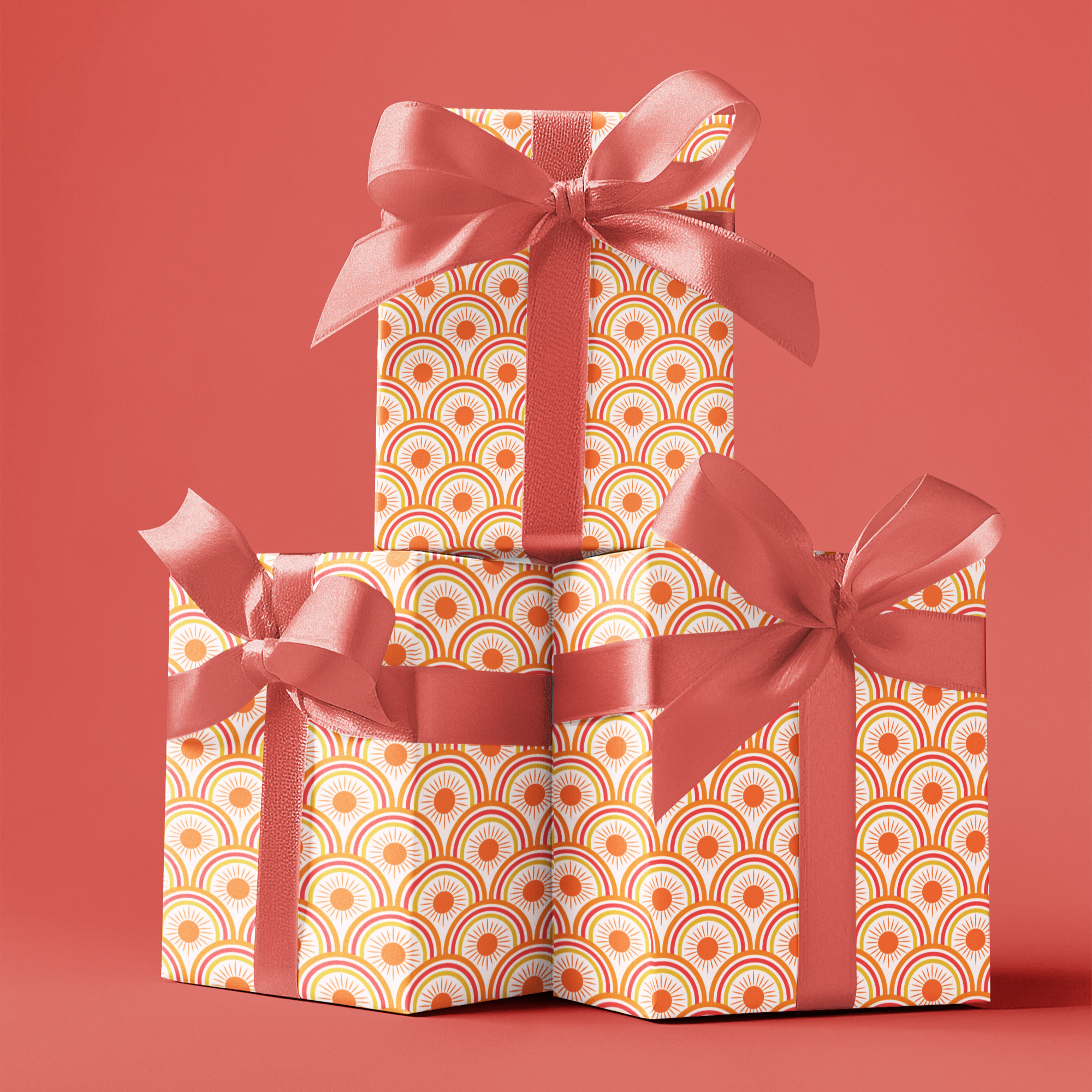 Three stacked gift boxes with decorative ribbons on a red background