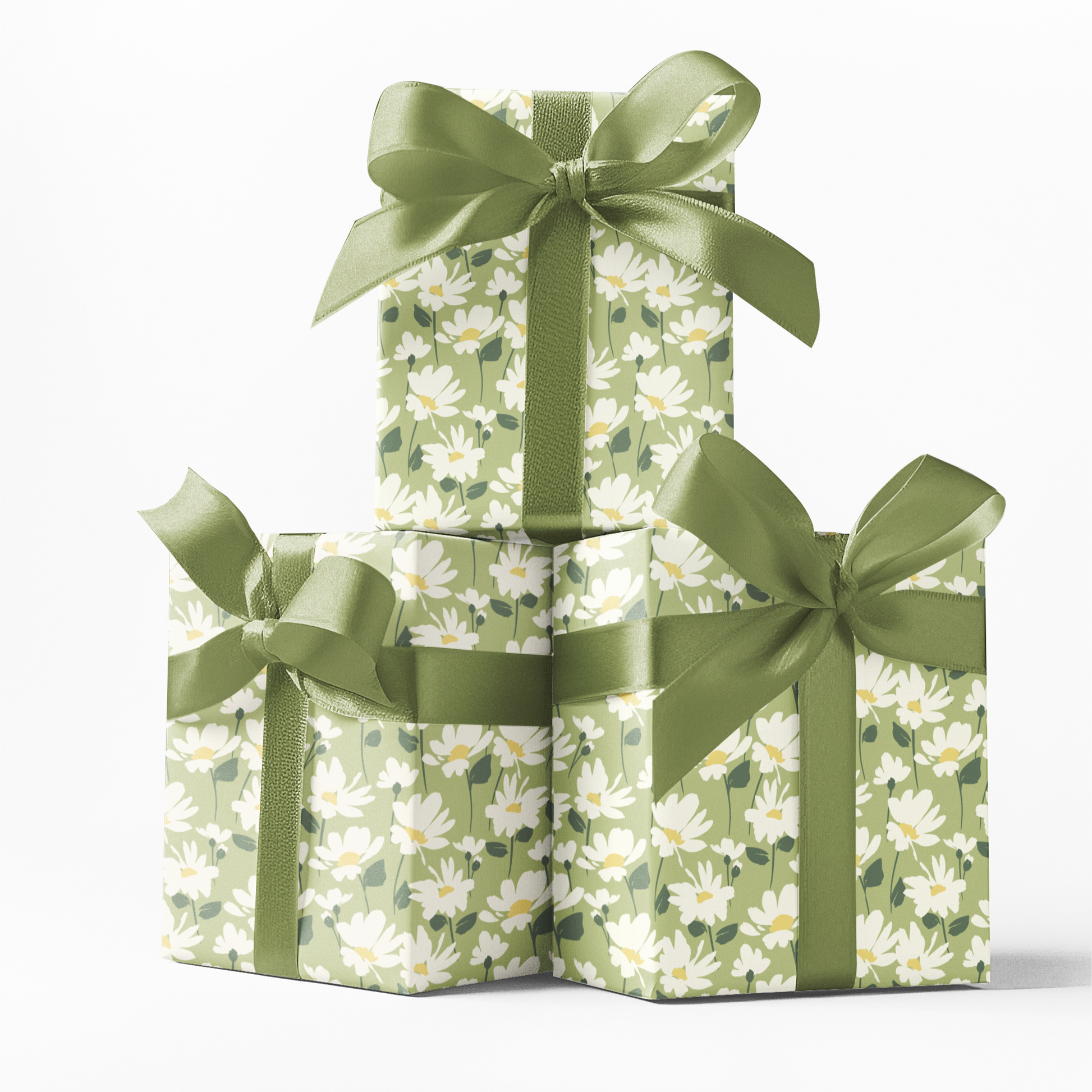 Three stacked gift boxes with floral patterns and green ribbons on a white background
