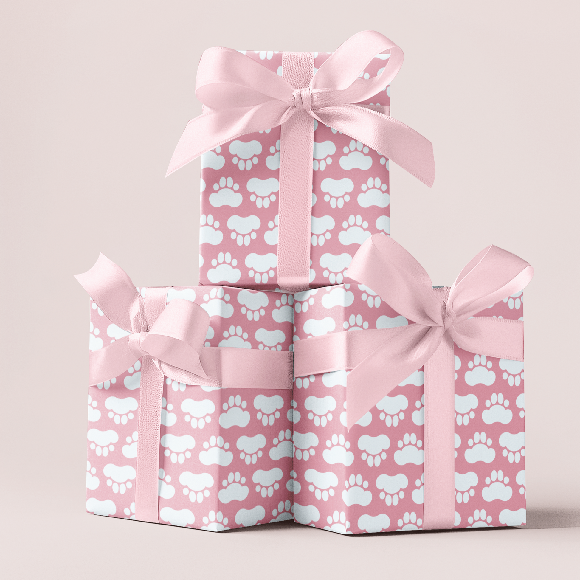 Paw print pink gift wrapping paper with pink ribbons on a light pink background