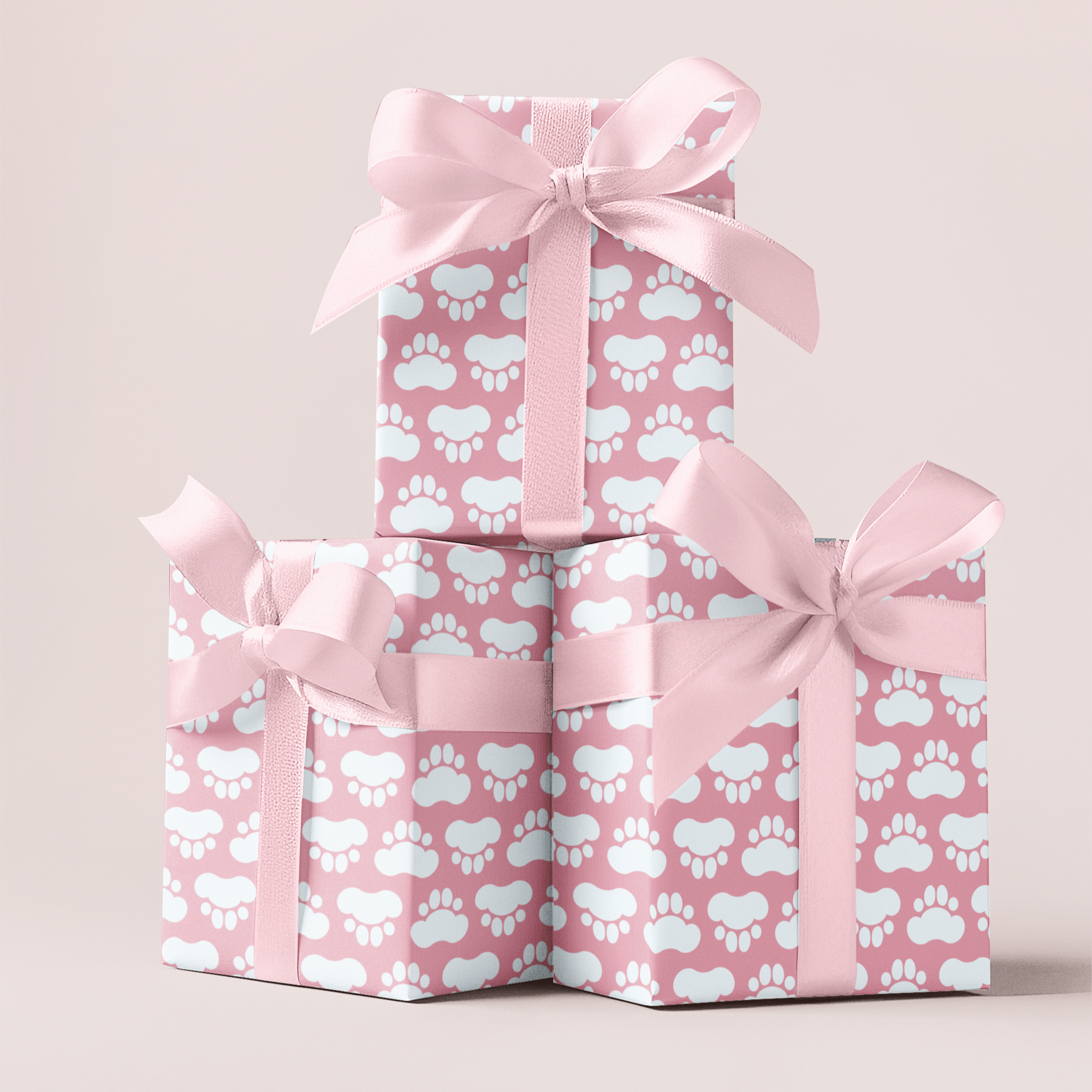 Paw print pink gift wrapping paper with pink ribbons on a light pink background