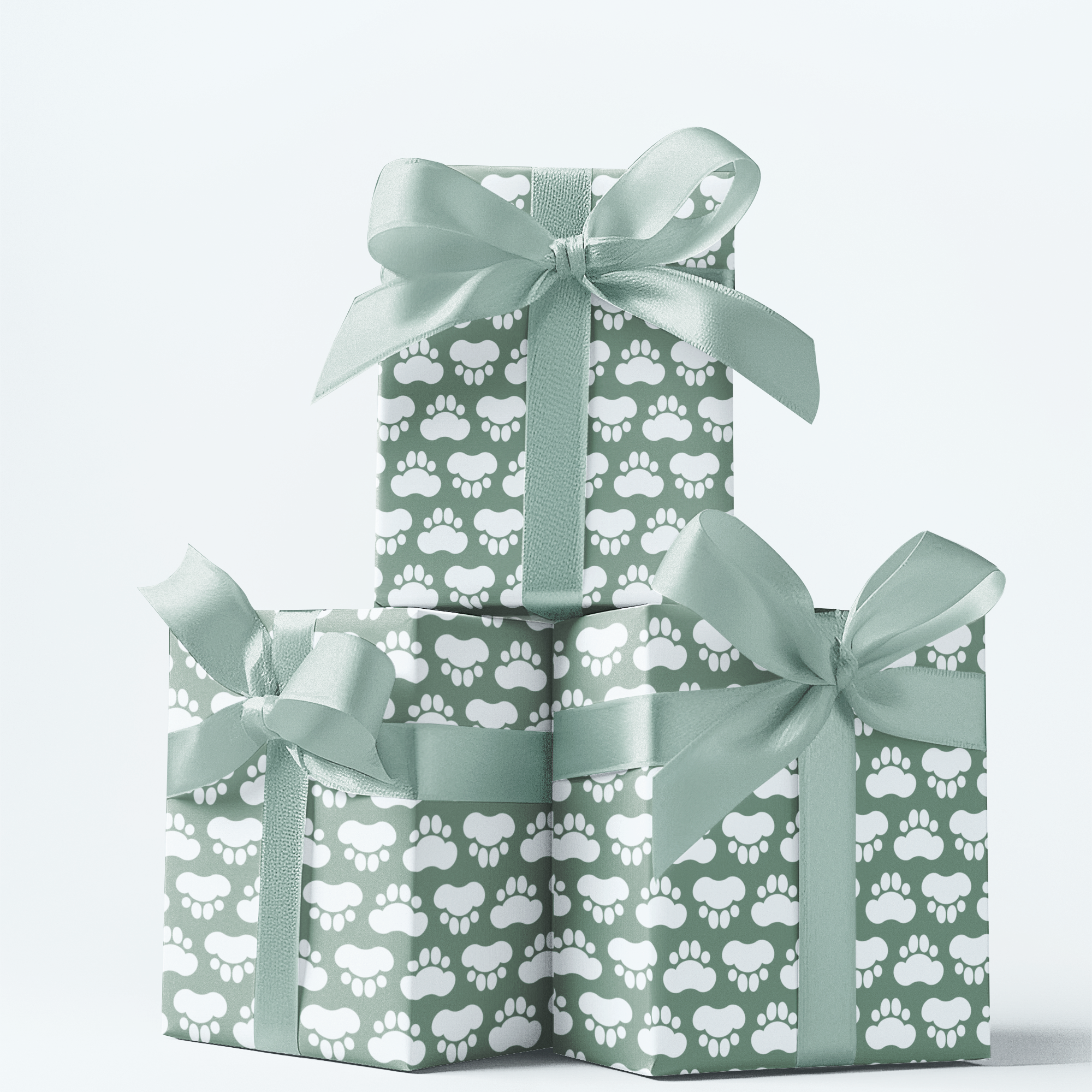 Three stacked gift boxes with paw print pattern and green ribbons on a white background