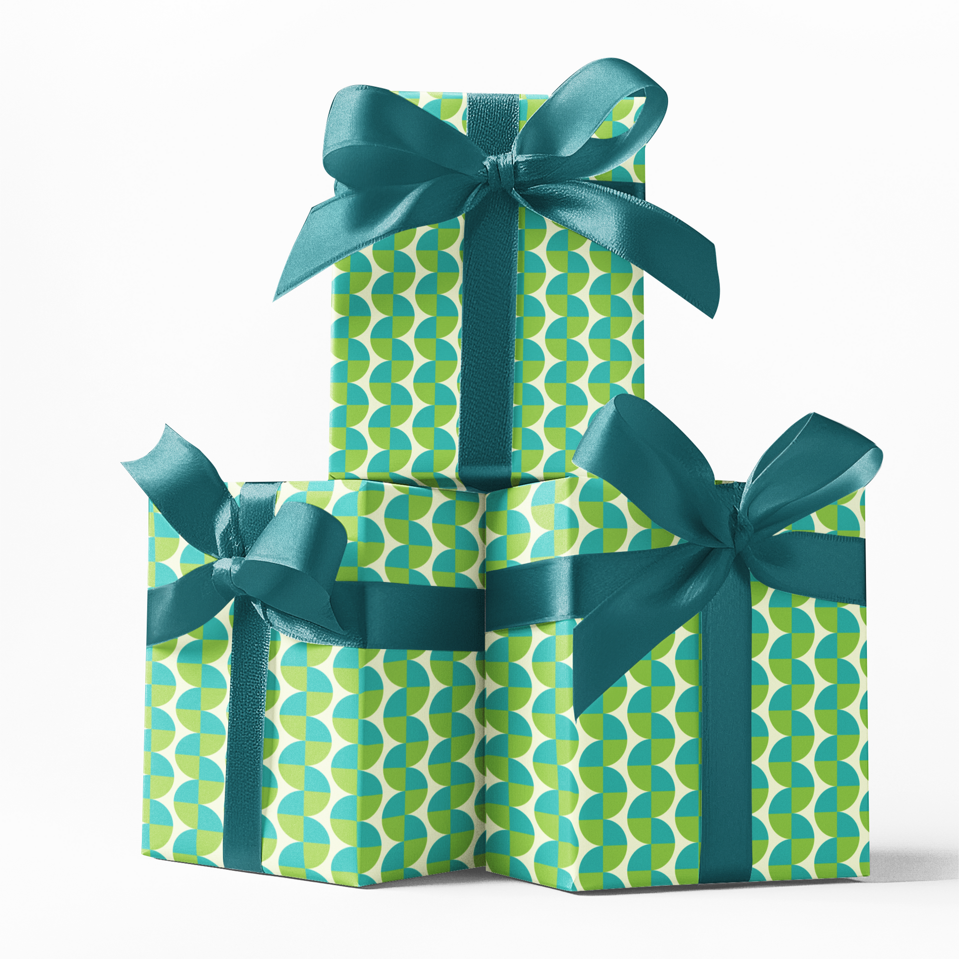 Three gift boxes with green and blue patterned wrapping paper and ribbons on a white background