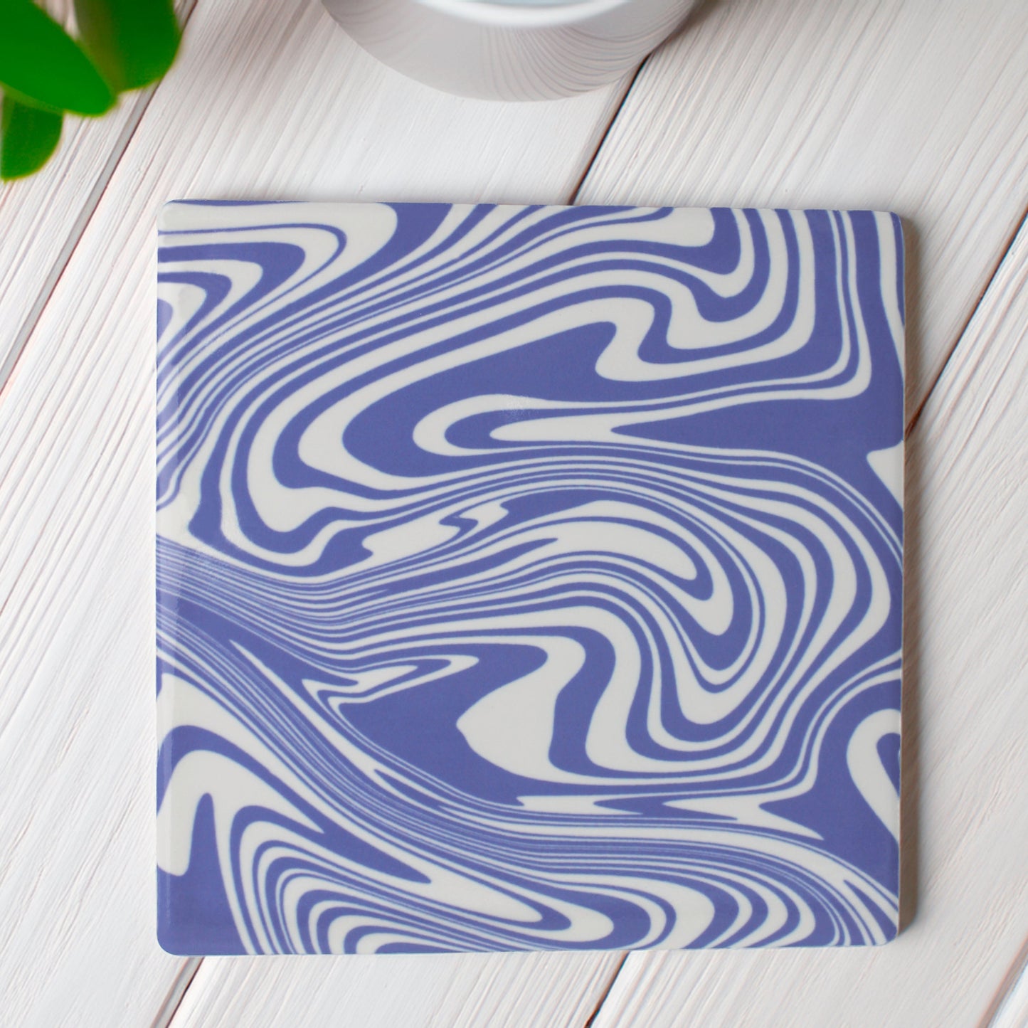 Our bright blue modern coaster is a burst of colour with swirls in blue and white.
Add a burst of personality to your space with our Funky Swirl Abstract Ceramic Coaster Set. Featuring vibrant, playful swirling patterns, these coasters are designed to liven up any room.

Choose from blue, orange, sage green, or yellow. Want a unique combination? You can mix and match up to four colours, just specify your choices and how many of each!

Available in matte or gloss finish to match your style.