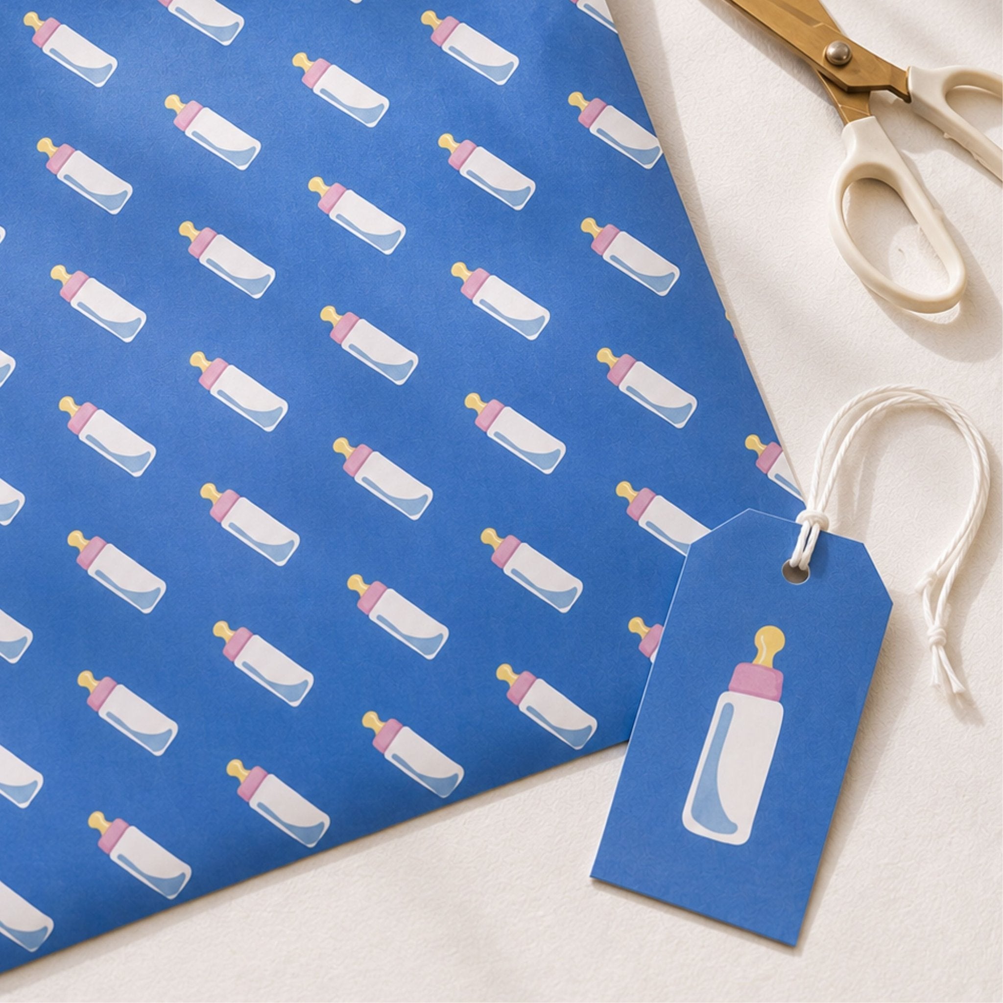 Blue baby bottle gift wrap with matching personalised-style gift tag