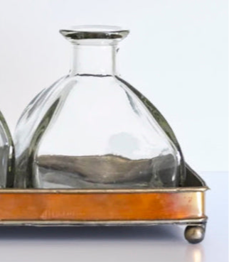 Elegant Glass Bottle Vase Set on Copper Tray