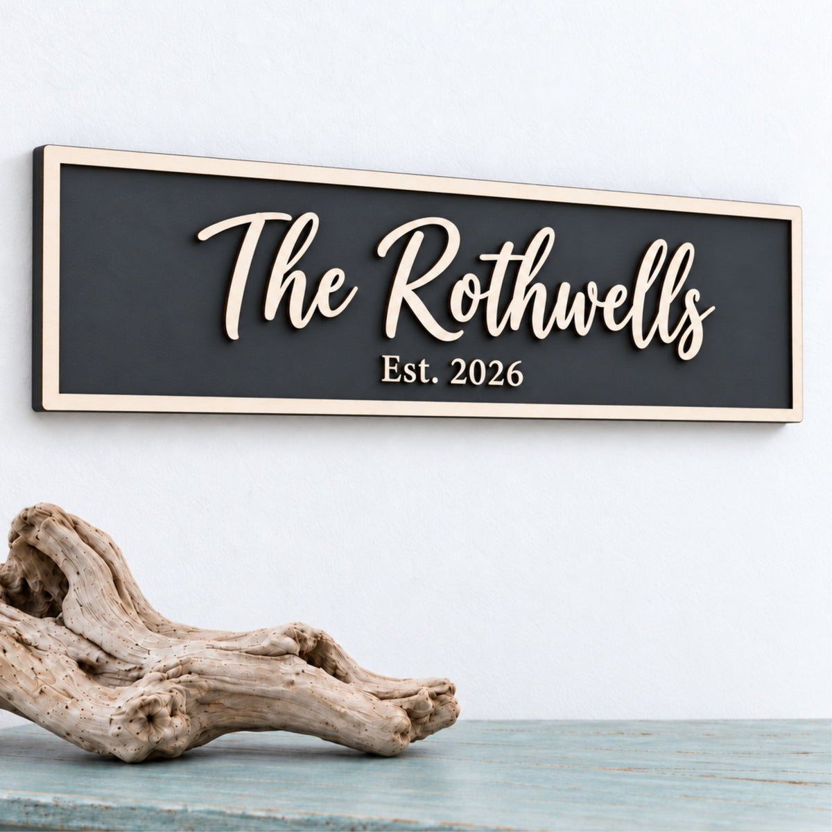 Charcoal personalised family sign reading “The Rothwells, Est. 2026”, with raised wooden script and a natural wood border.
