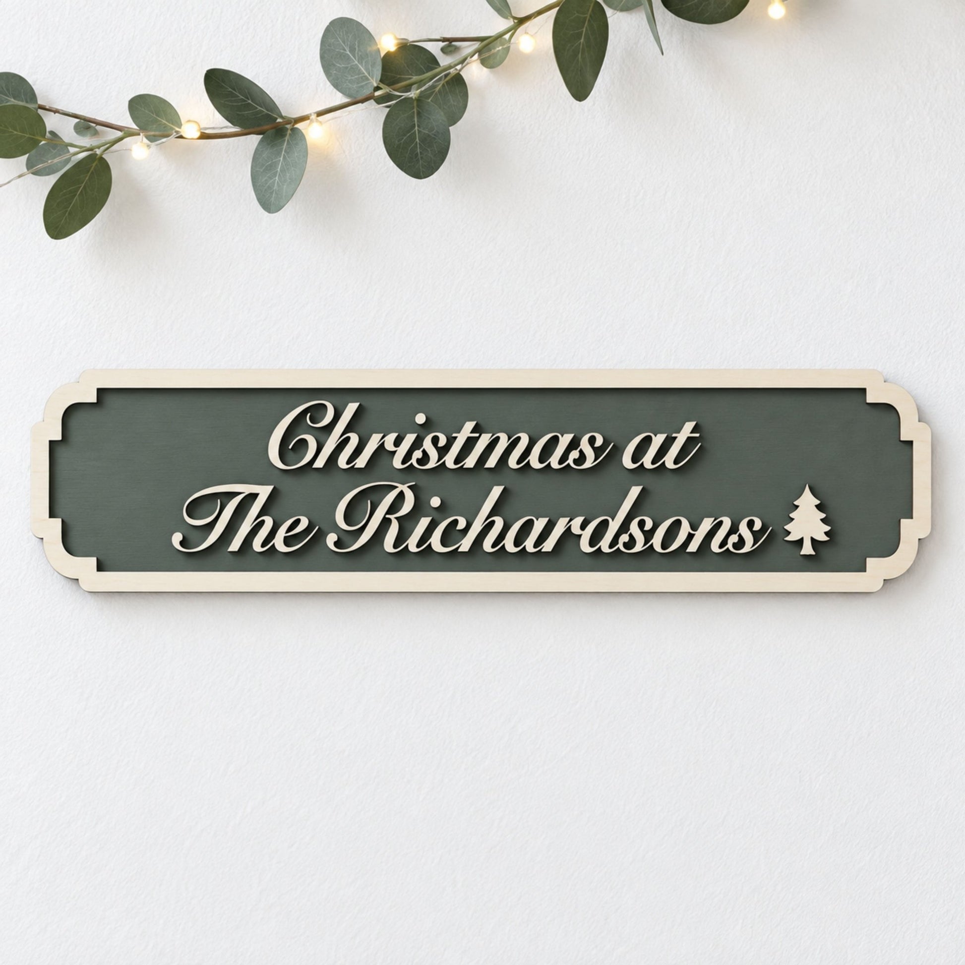 Forest green “Christmas at The Richardsons” sign with raised wooden script lettering and a Christmas tree detail.