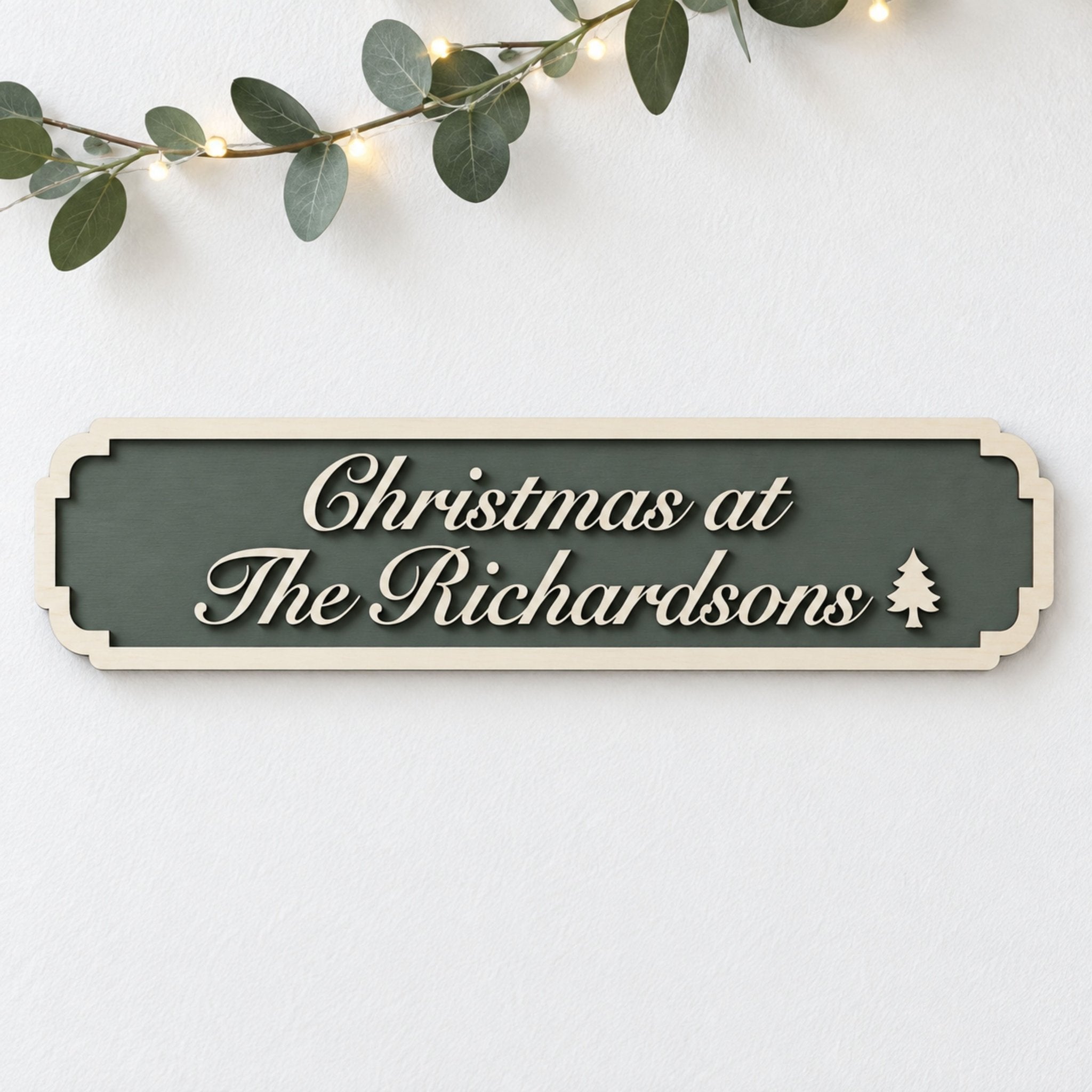 Forest green “Christmas at The Richardsons” sign with raised wooden script lettering and a Christmas tree detail.