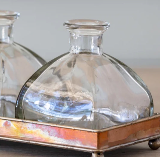 Elegant Glass Bottle Vase Set on Copper Tray