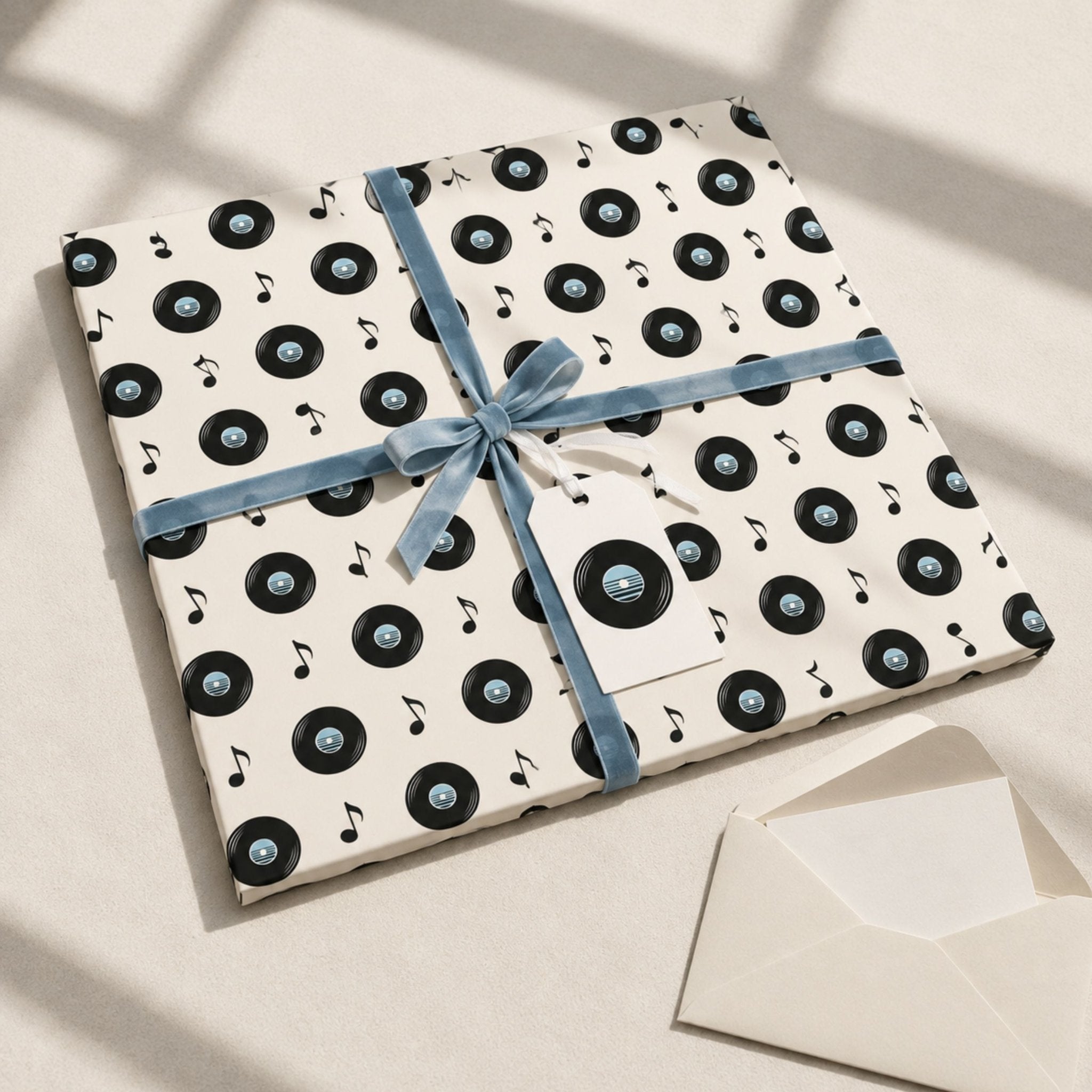 Present wrapped in retro vinyl record gift wrap with soft blue ribbon