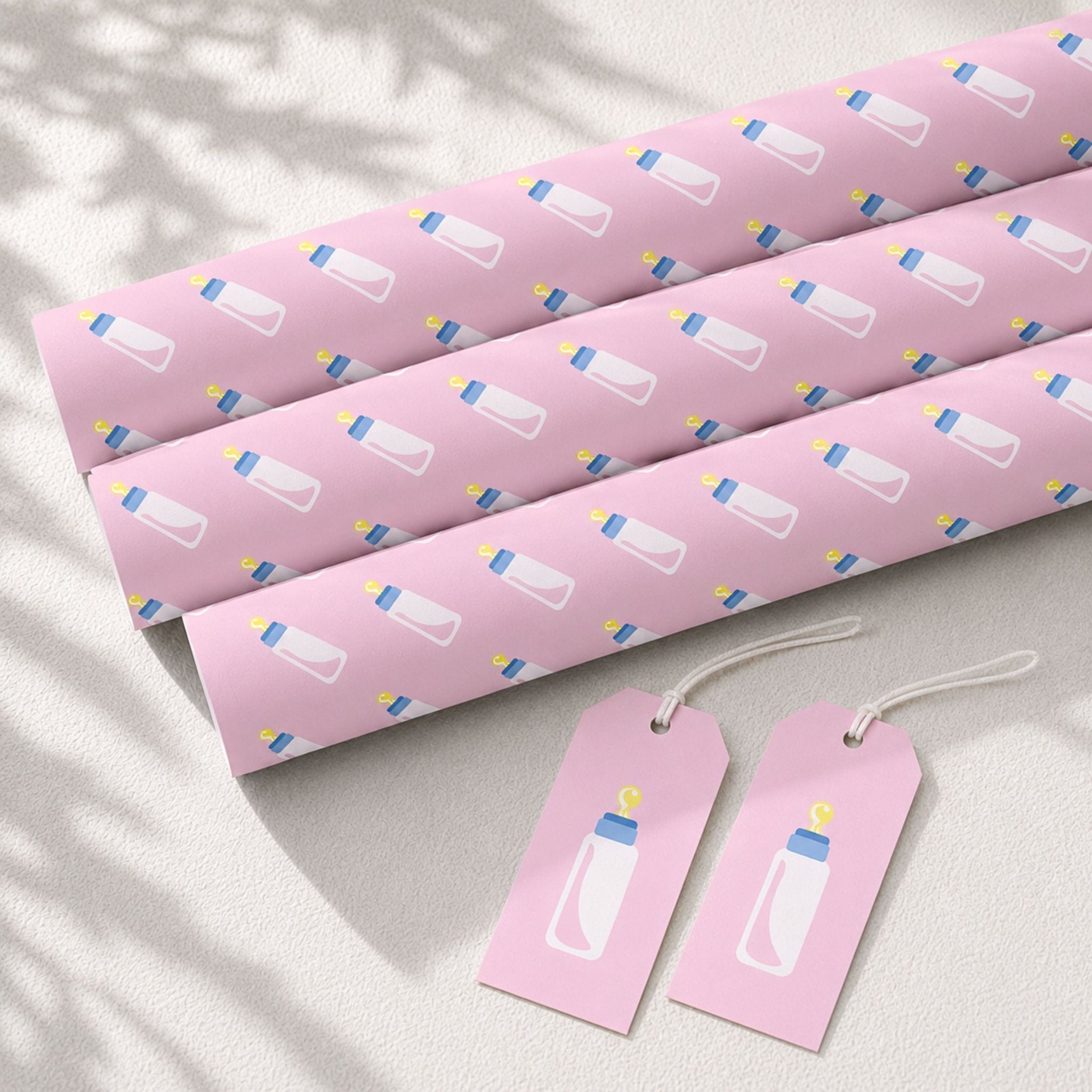 Pink baby bottle wrapping paper rolls with matching gift tags