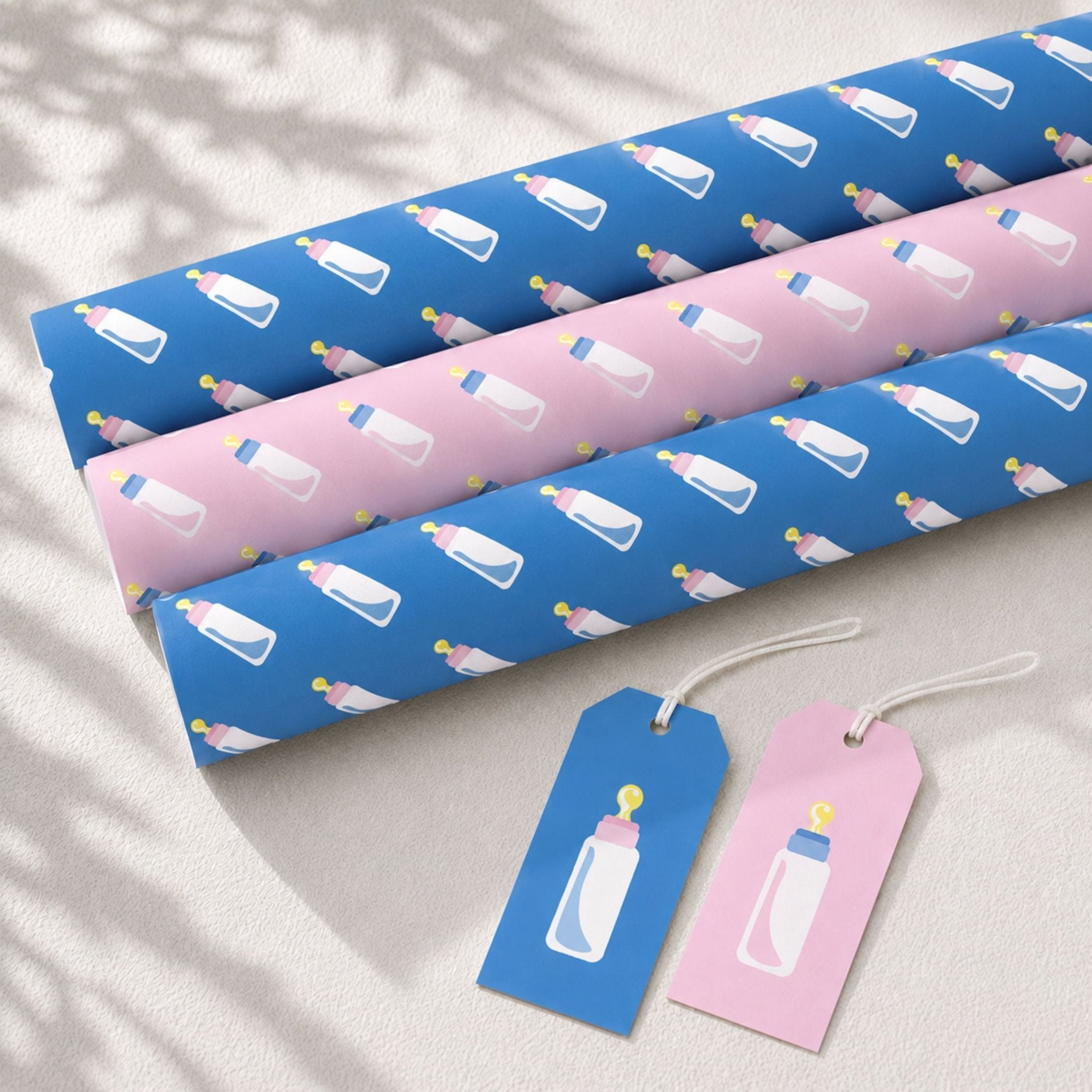 Pink and blue baby bottle wrapping paper with coordinating gift tags