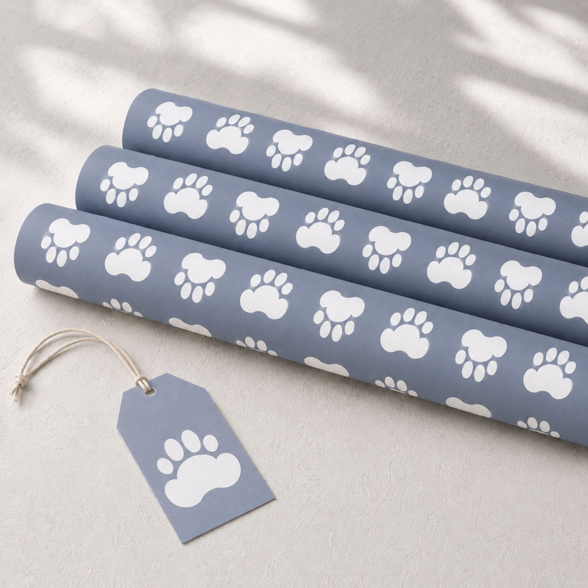 Blue dog paw wrapping paper rolls with matching gift tag