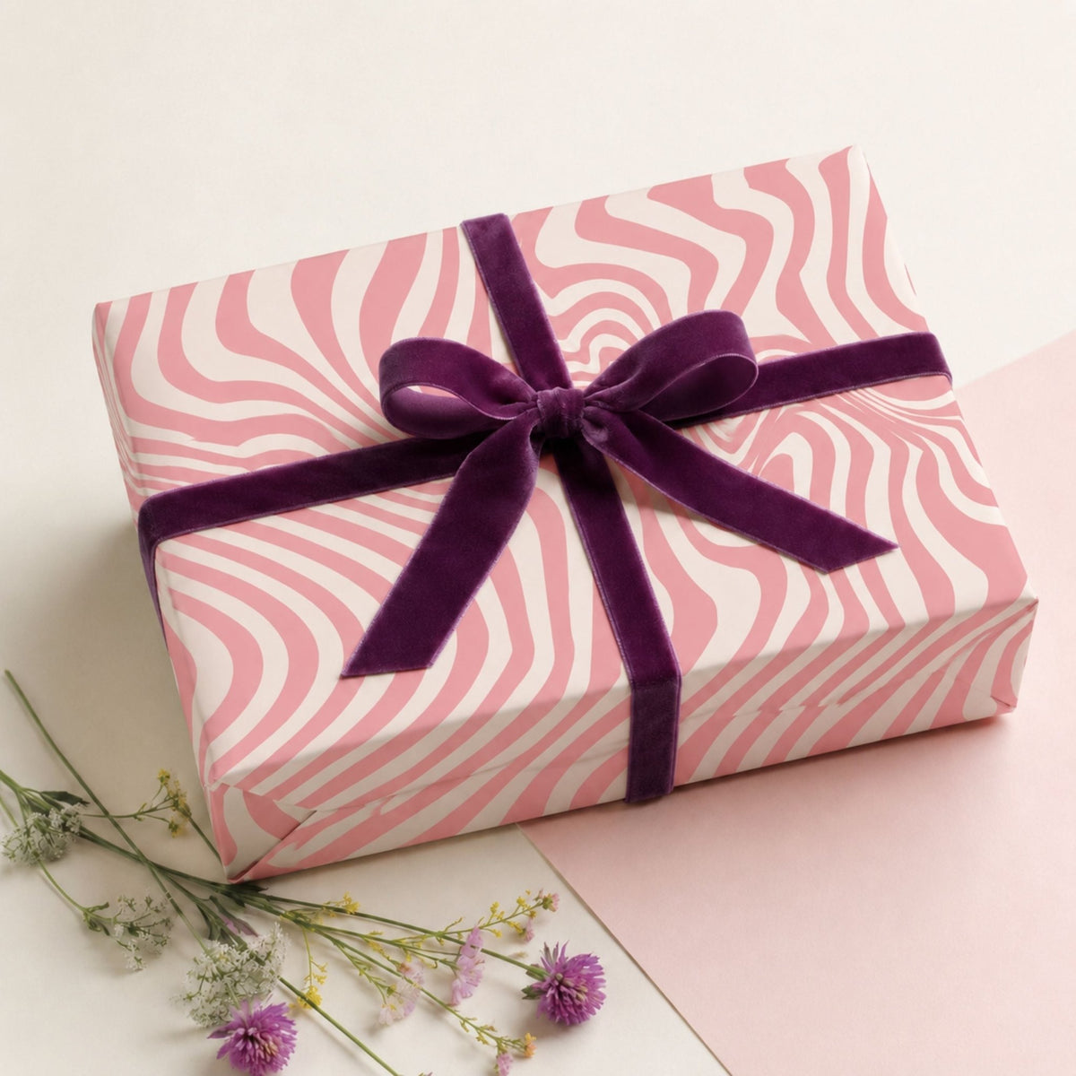 Pink Retro Swirl gift wrap with purple velvet ribbon