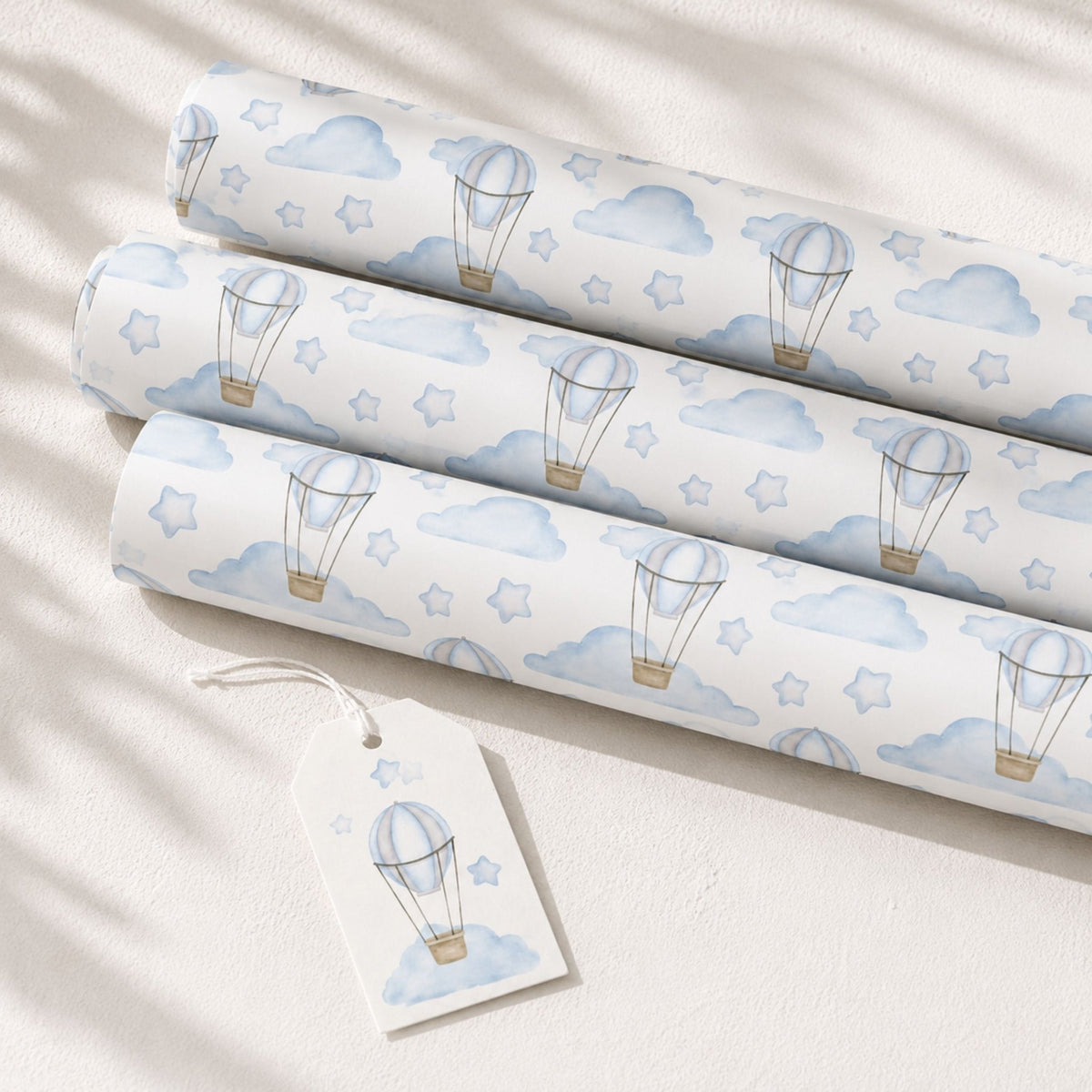 Rolls of blue Hot Air Balloon wrapping paper with matching gift tag