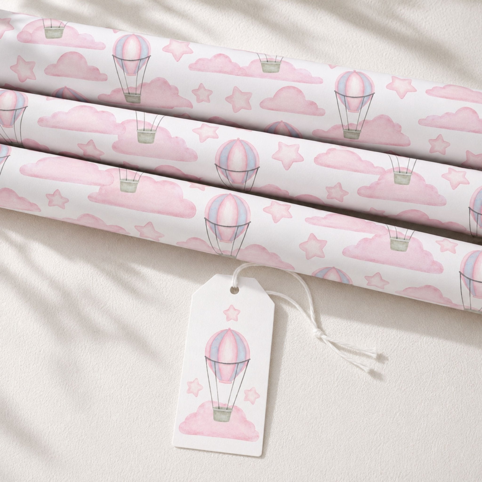 Rolls of pink Hot Air Balloon wrapping paper with matching gift tag