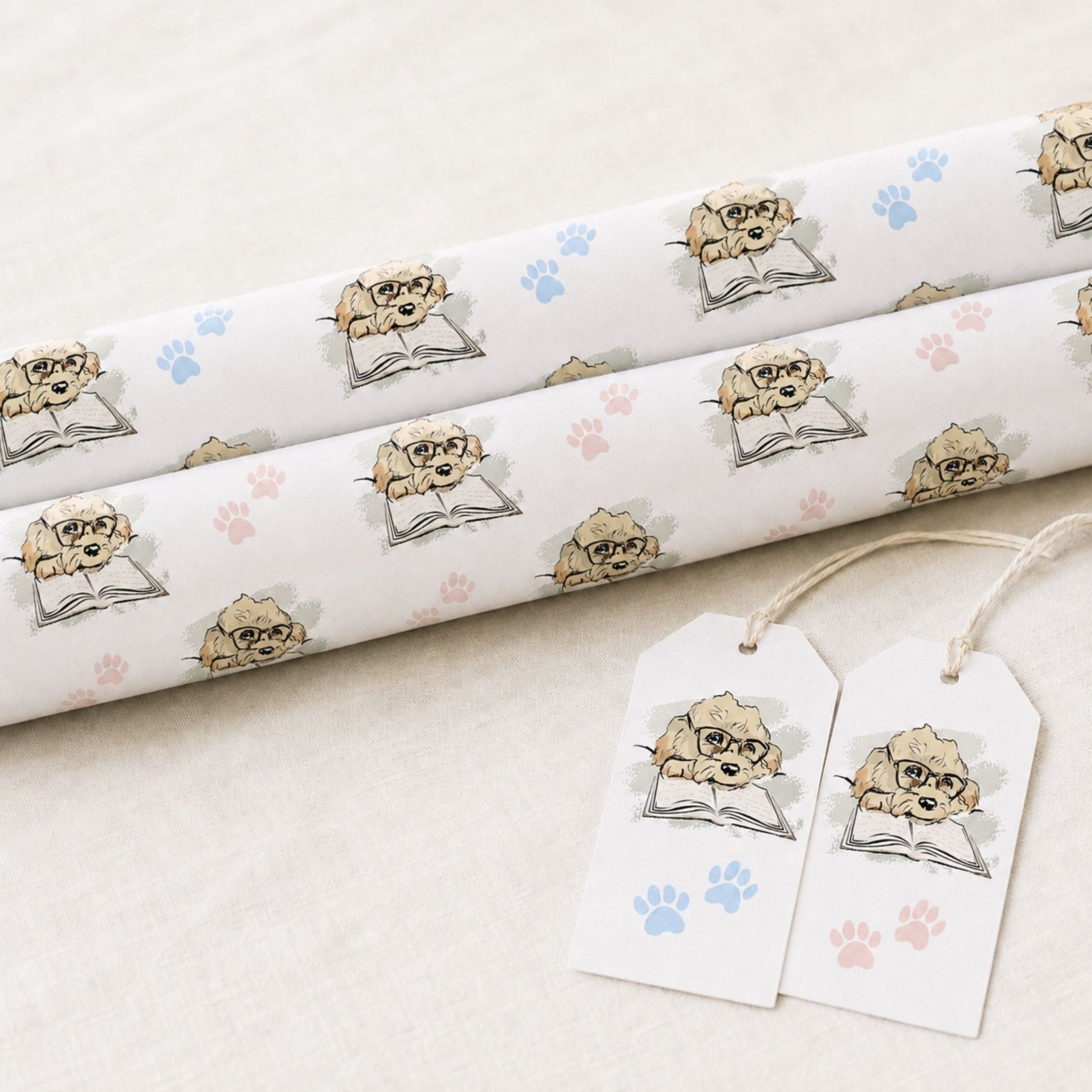 Rolls of Cavapoo dog wrapping paper featuring illustrated Max and blue paw prints with matching gift tags
