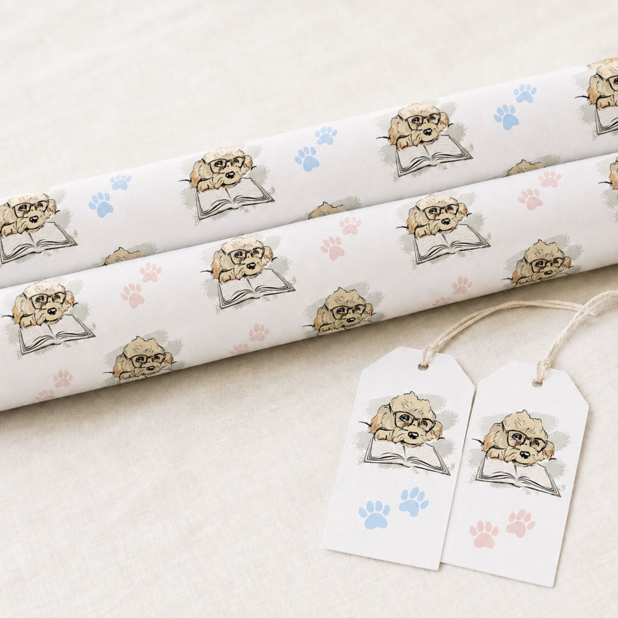 Rolls of Cavapoo dog wrapping paper featuring illustrated Max and blue paw prints with matching gift tags