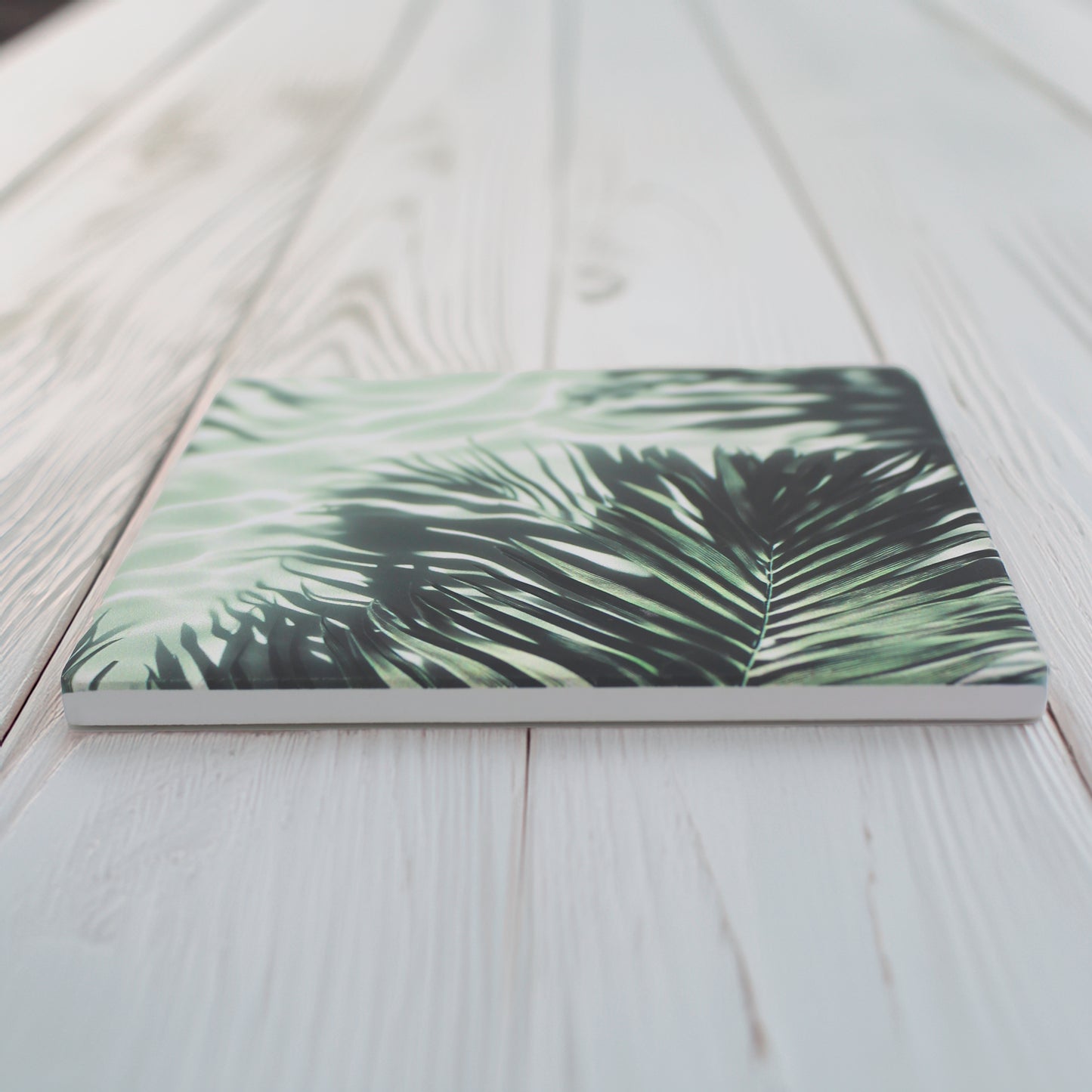 Bring a touch of the tropics to your space with our Jungle Leaf Pattern Ceramic Coaster Set. 

This set of four includes two variations of lush, leafy designs, offering a beautiful mix of botanical style, choose from green or pale grey option.

Available in matte or gloss finish to complement your style. 

Each coaster is finished with a crisp white, cork-backed base for both beauty and practicality.

10 x 10cm