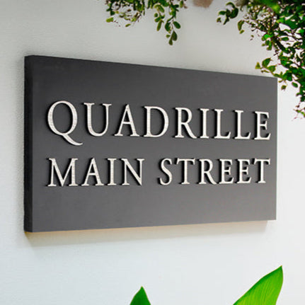 This modern 40 x 20 cm outdoor house sign adds style shown with wood effect raised design