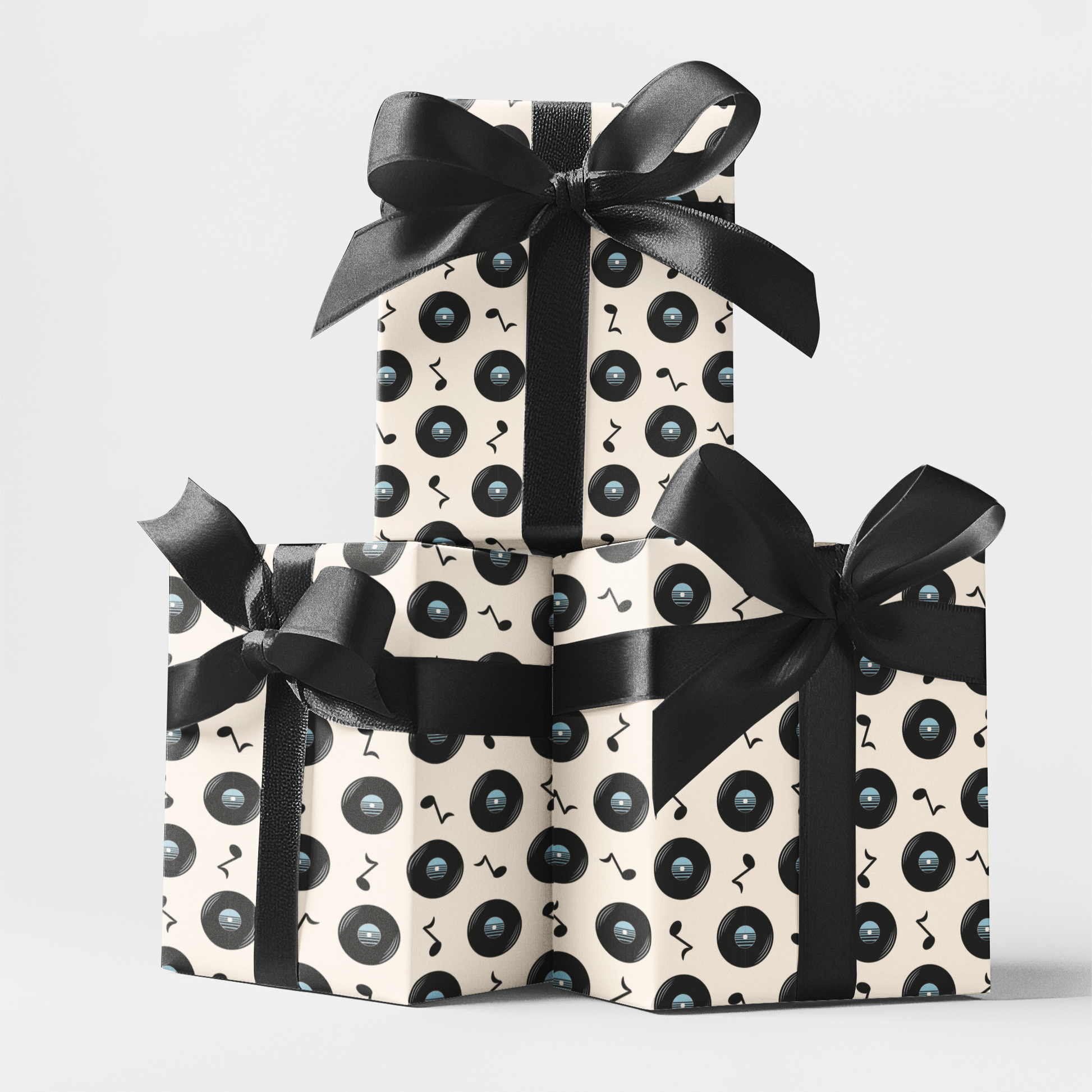 Three gift boxes wrapped in vintage record design perfect for music lovers with black and cream patterned 