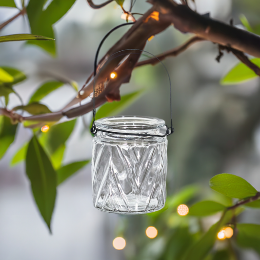 "Close-up of glass tea light holders with black wire, designed to provide a soft, flickering glow, perfect for hanging in your garden or patio.