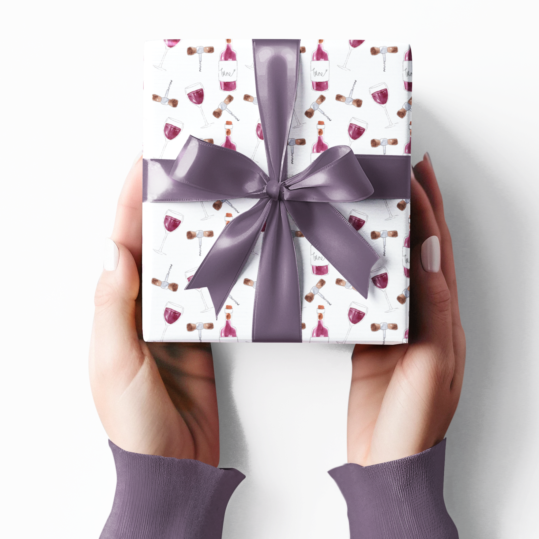 Gift box with a purple ribbon held by hands against a white background wine themed