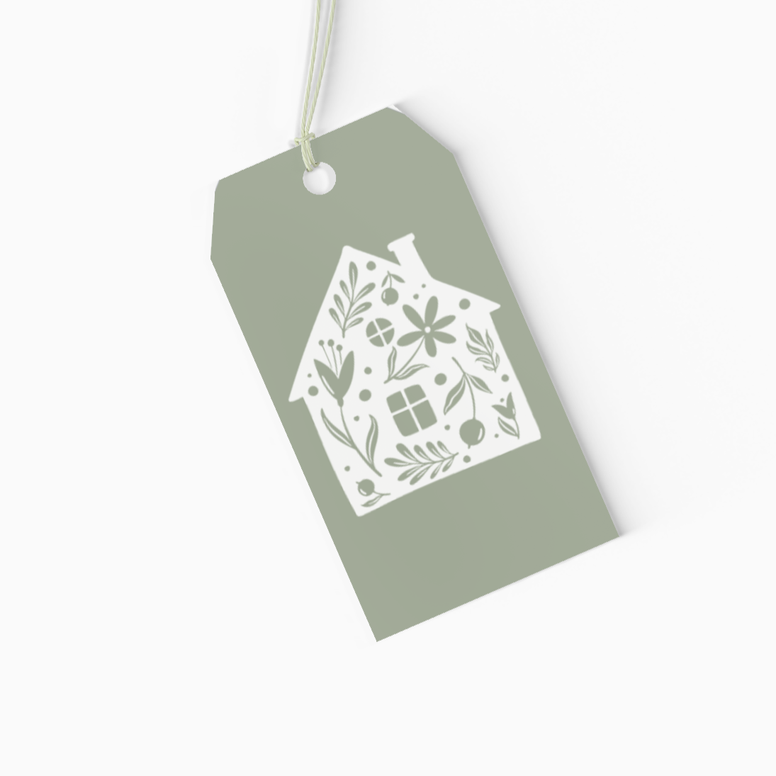 Green gift tag with a decorative house design on a white background