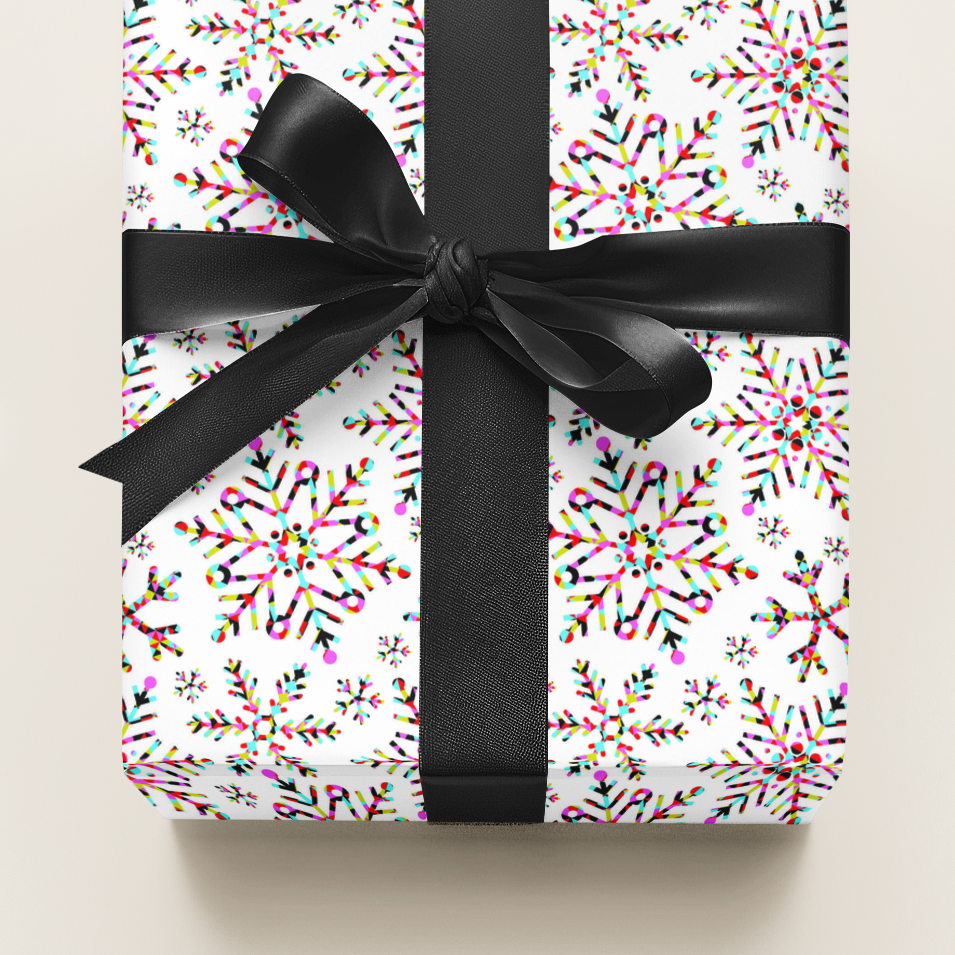 Gift wrapped in colourful paper wit pink turquoise lime green red and black against a white background with a black ribbon