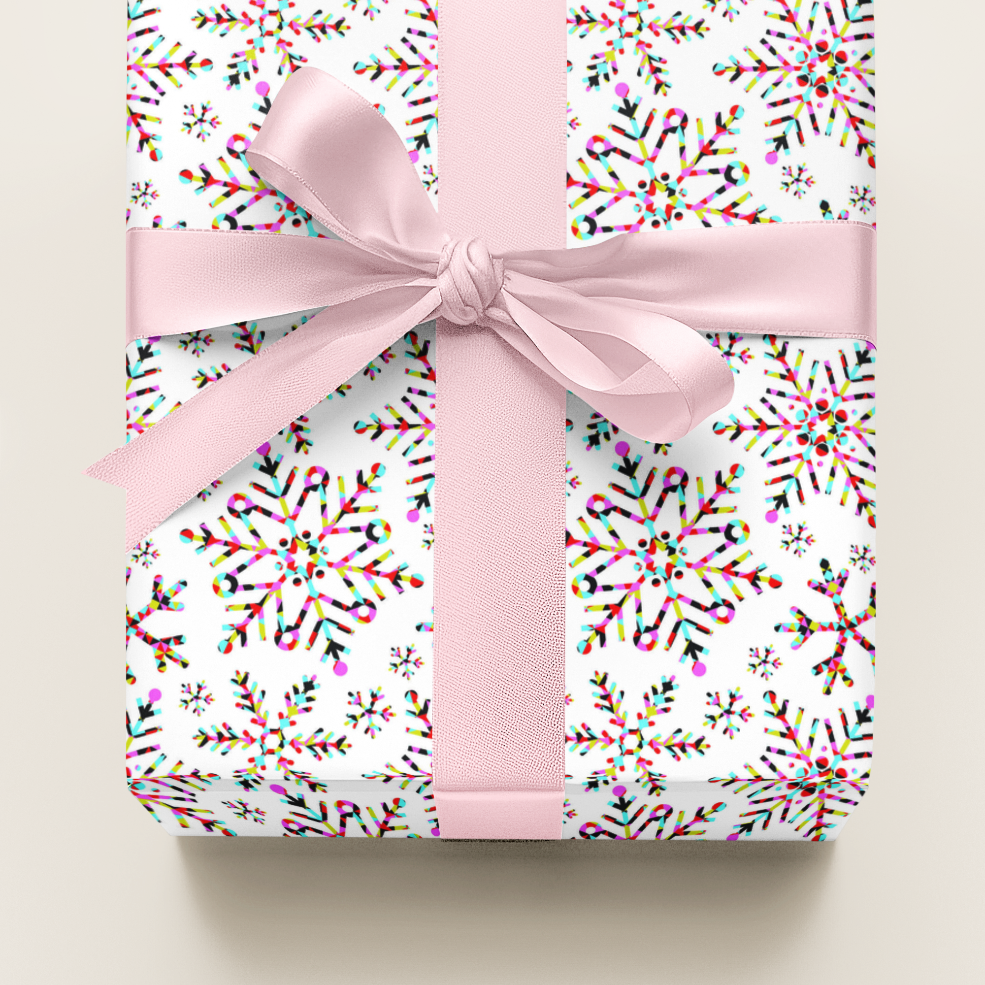 Christmas Gift wrap in colourful paper with a pink ribbon on a light background, perfect for wrapping girly gifts