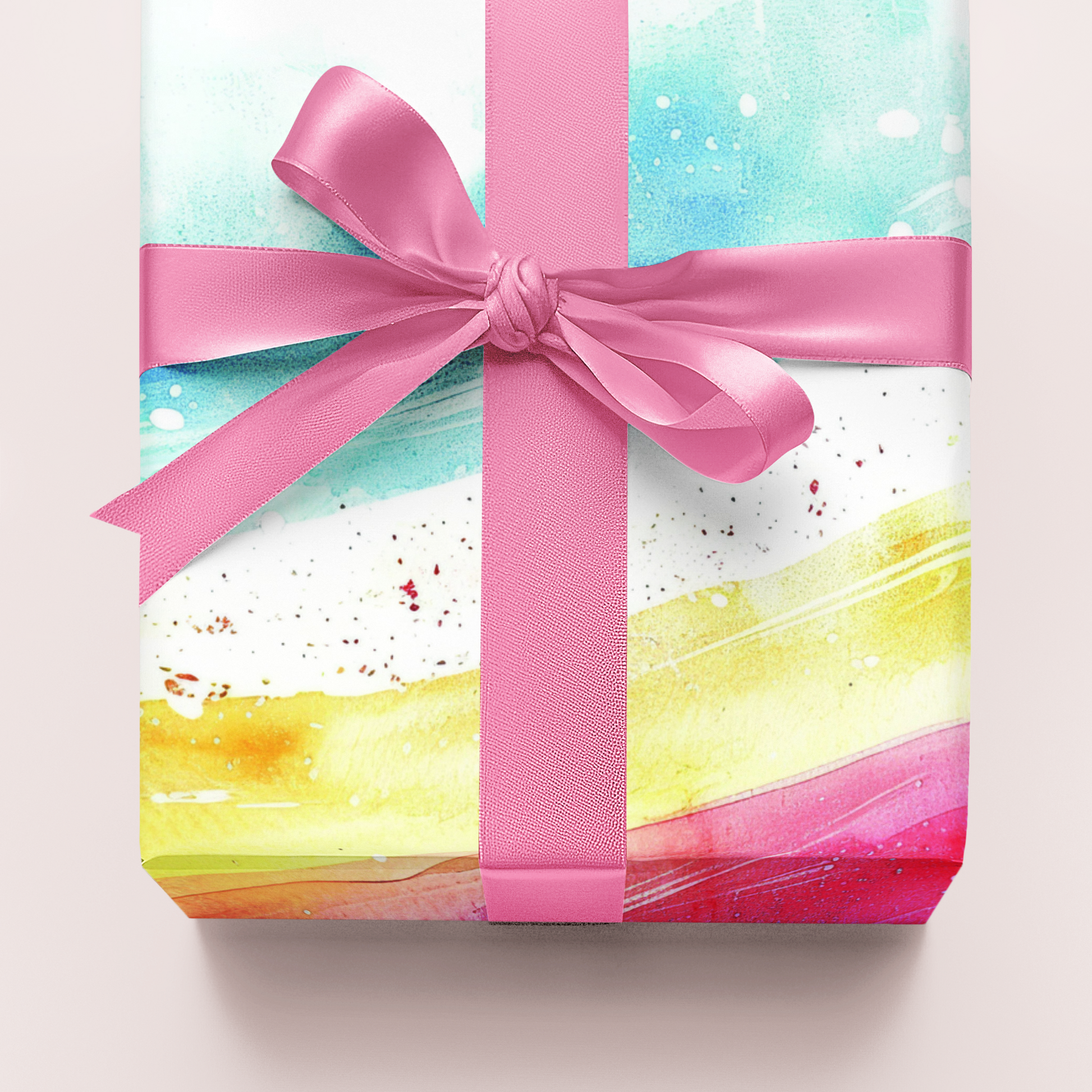 Gift wrapping paper with watercolour rainbowdesign and pink ribbon on a light background