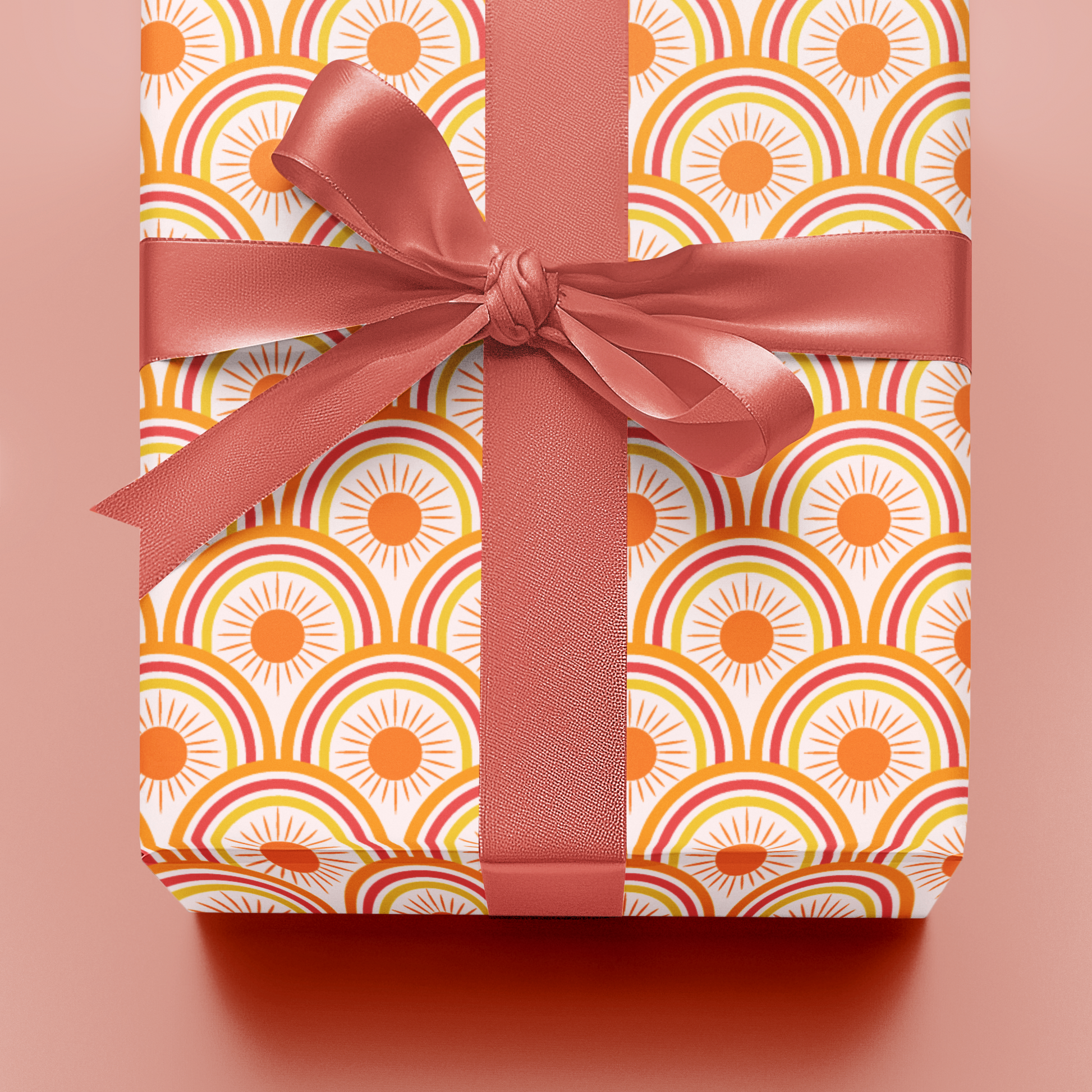 Gift box with geometric pattern and pink ribbon on a matching background