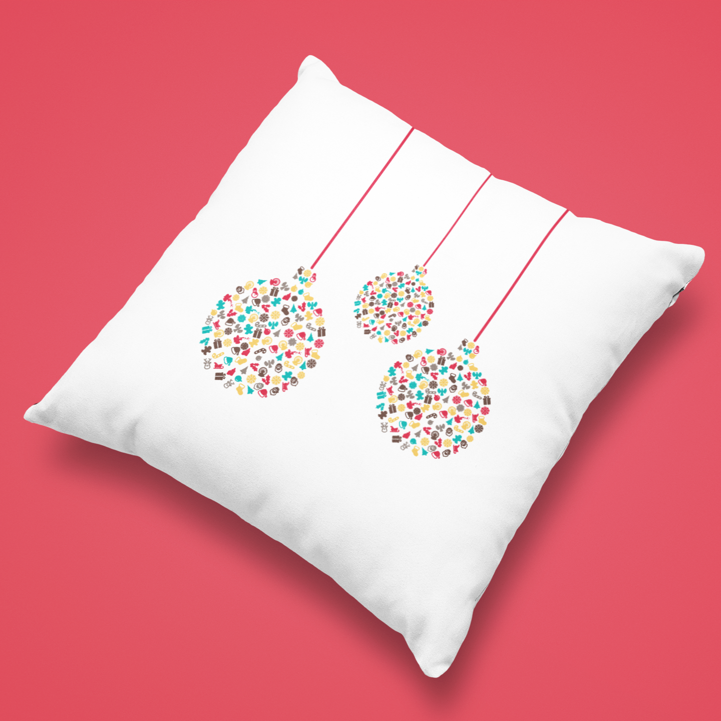 White pillow with colourful bauble design decorations on a red background