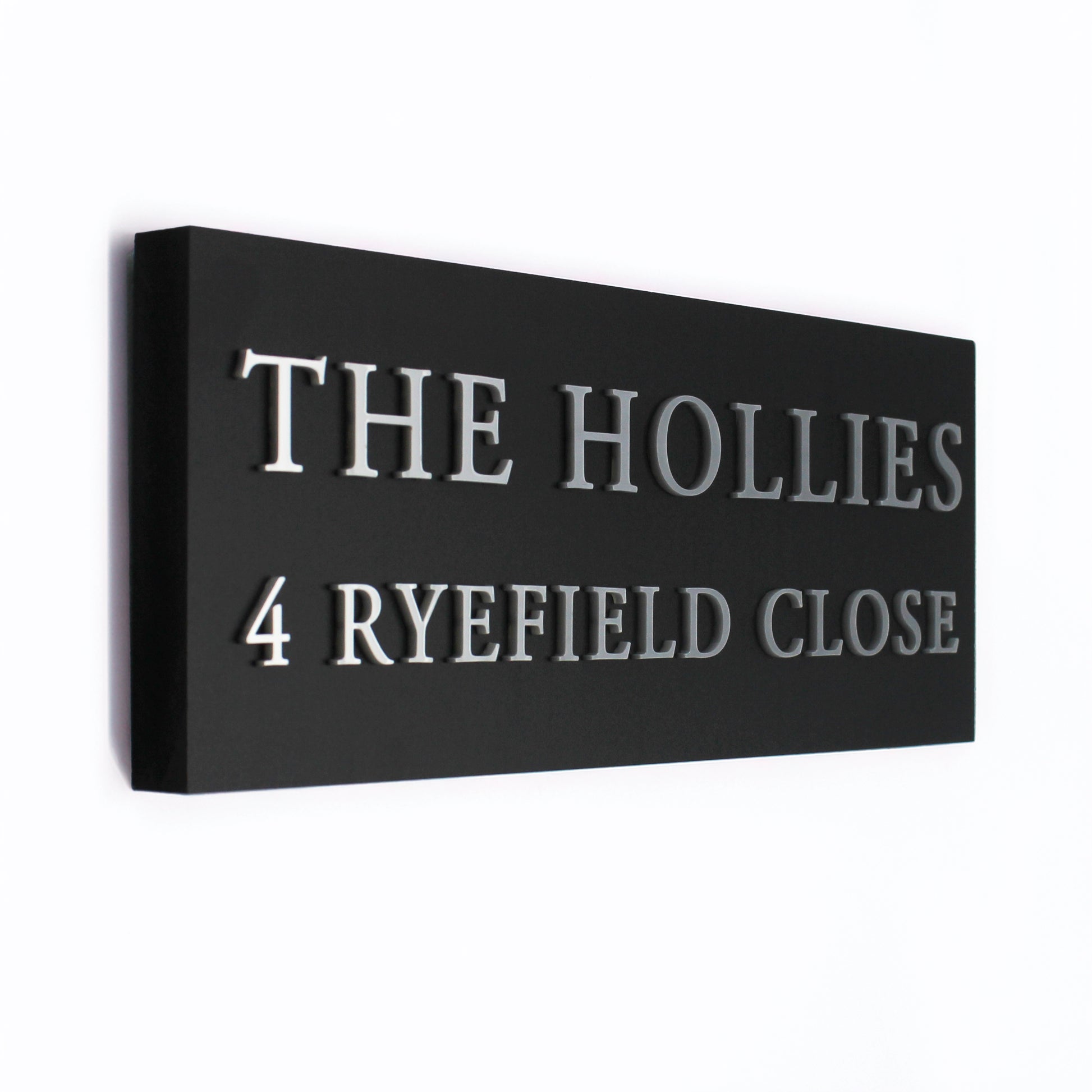 Black rectangular sign with silver text this is a side view to show how the raised wording stands out beautifully